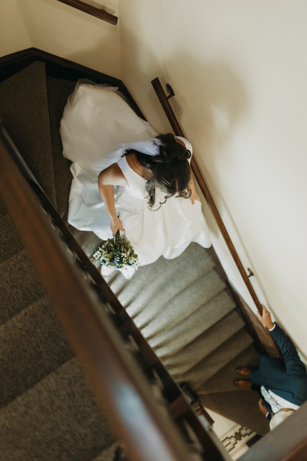bride walking down stairs heading to father