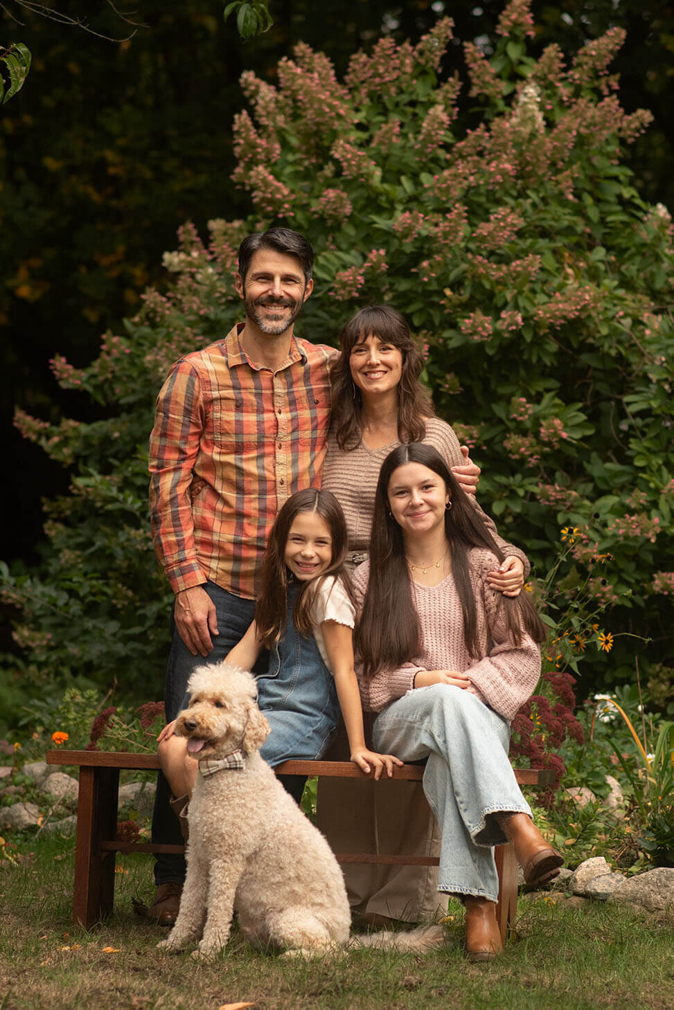 A family poses with their poodle in this backyard family session in Reading, MA.