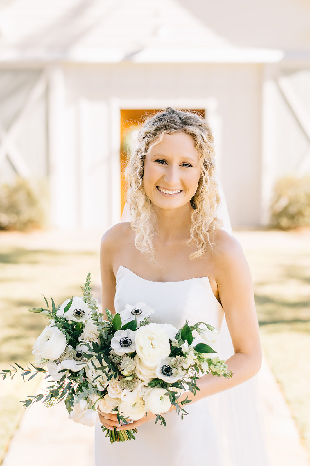 Bride with white and green floral bouquet designed by Abby Grace Florals at Saluda SC wedding