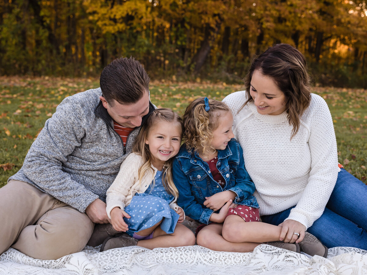 family posing for portraits at the park