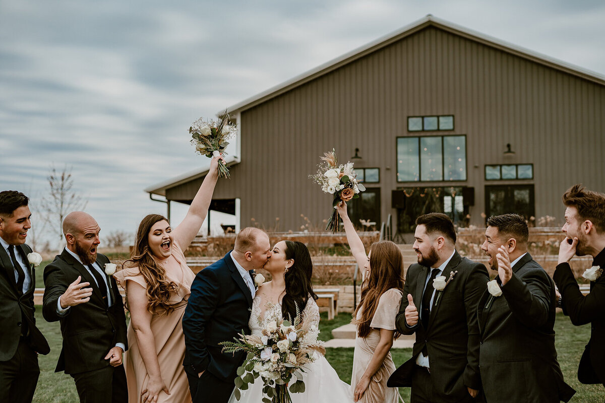 storyteller-collective-photo-co-bridal-party-cheering-barn-wedding-ashton-hill-farm-cedar-rapids-iowa