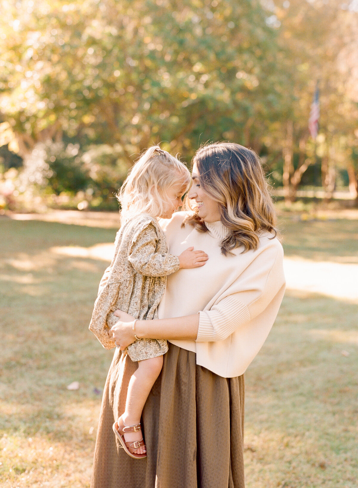 Mom and daughter touch foreheads during a family session in Wake Forest. Image by Raleigh maternity photographer A.J. Dunlap Photography.