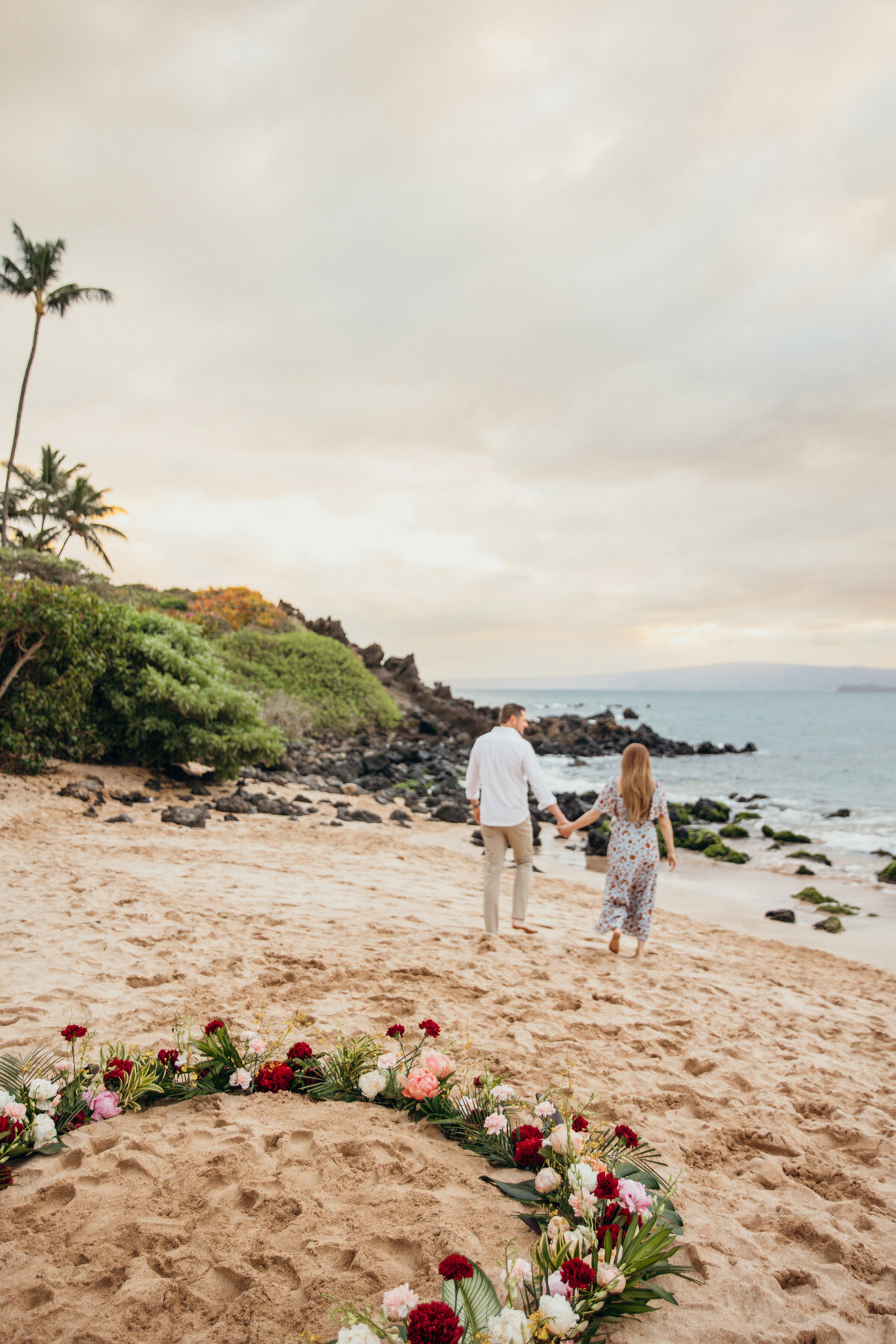 Hawaii Engagement Photographer captures couple walking on beach after intimate beach proposal
