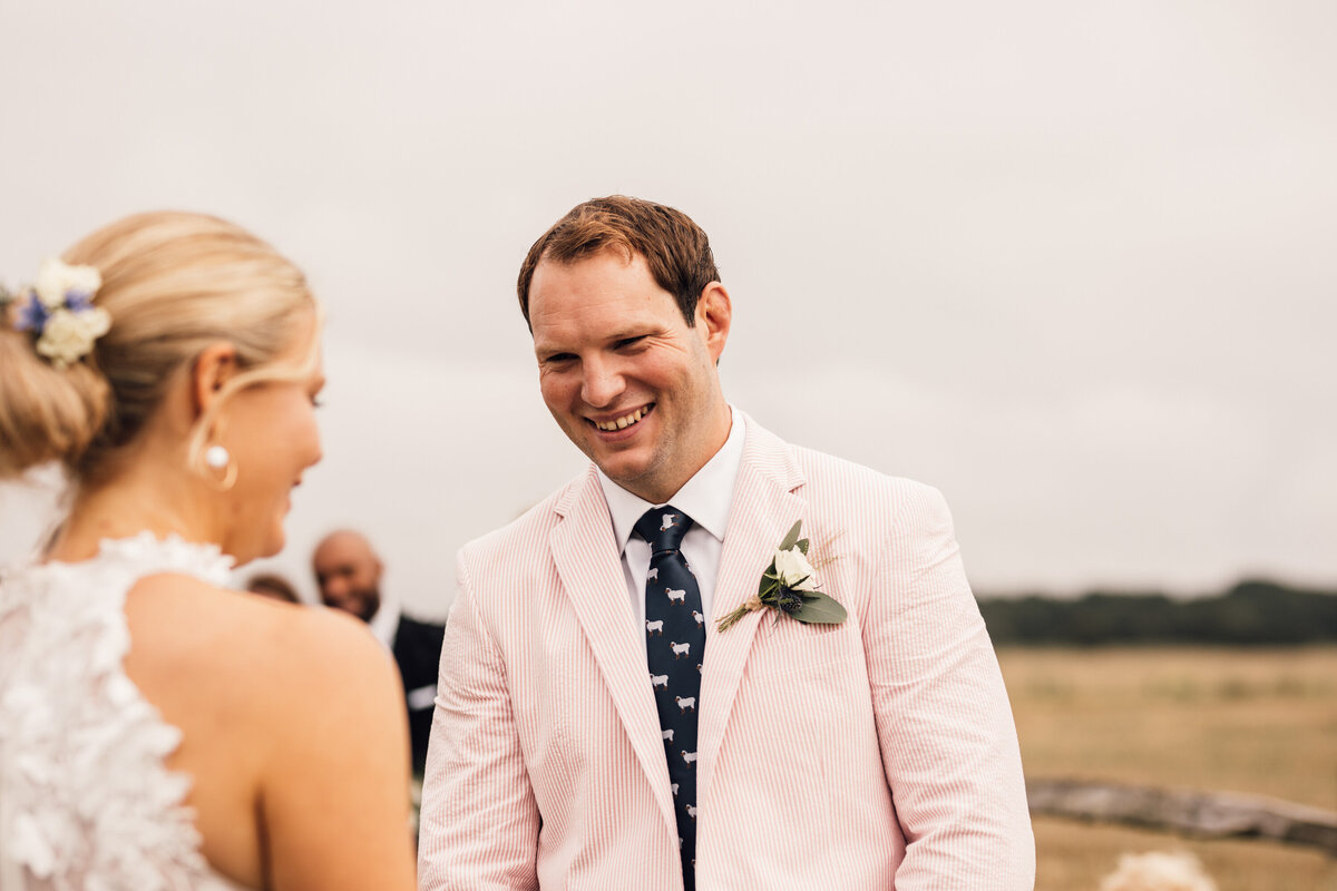 Groom smiling at bride