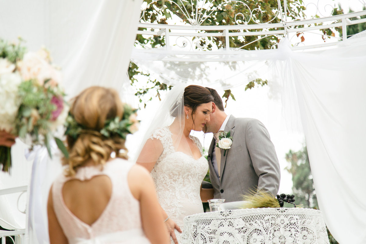 Bride and groom pray at 1880 Union Hotel Wedding