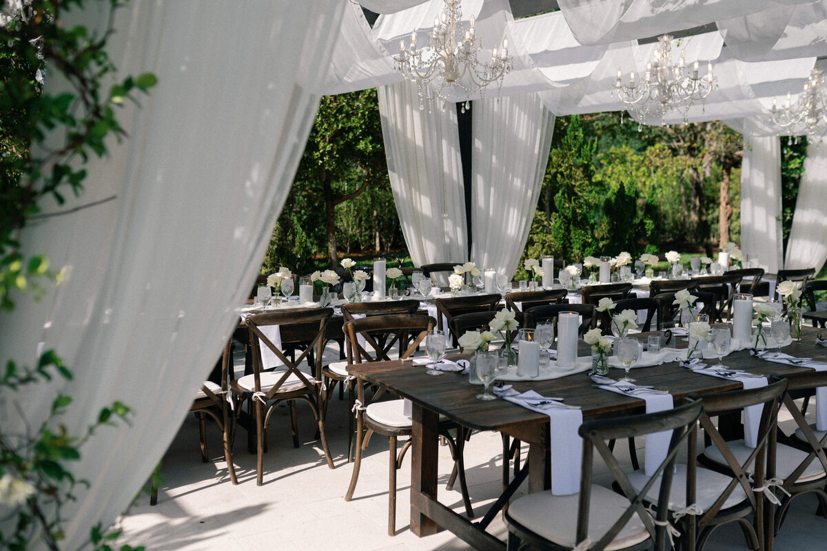 Elegant outdoor reception under chandeliers at La Casa Toscana wedding 