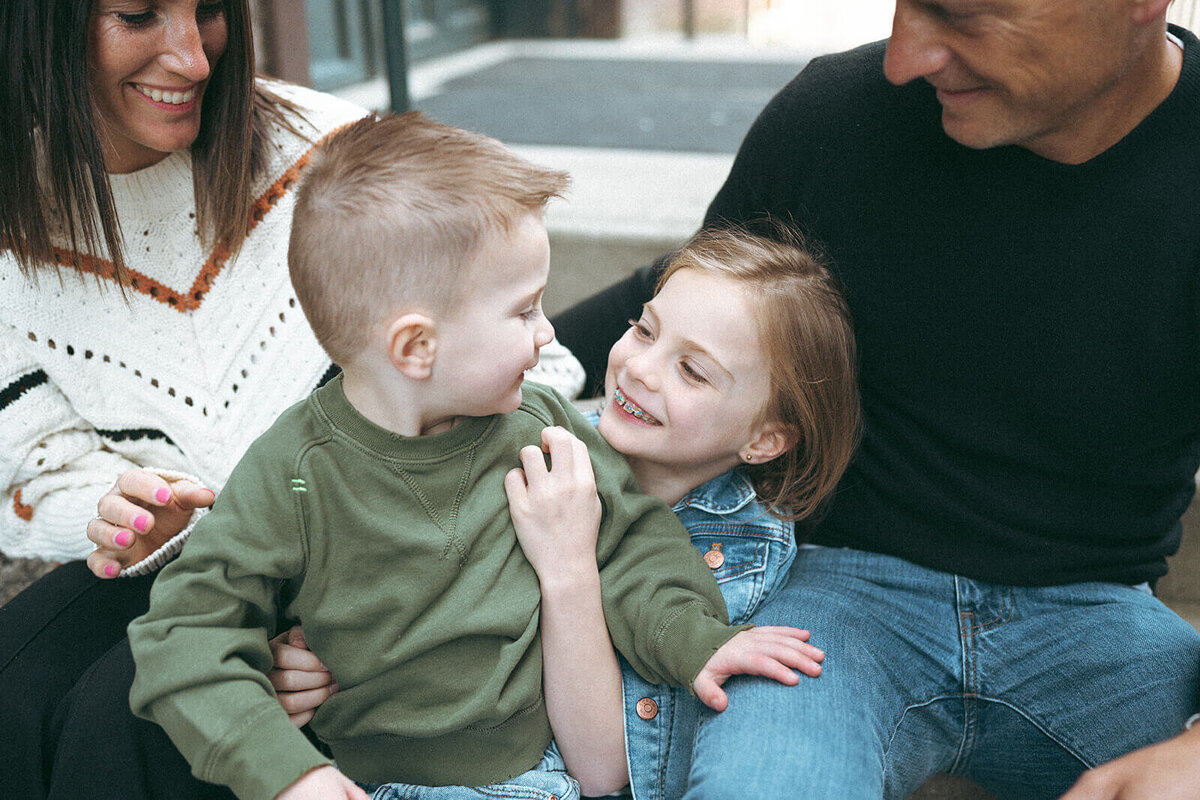 Brother and sister sharing a happy moment during a relaxed family session in Southern California