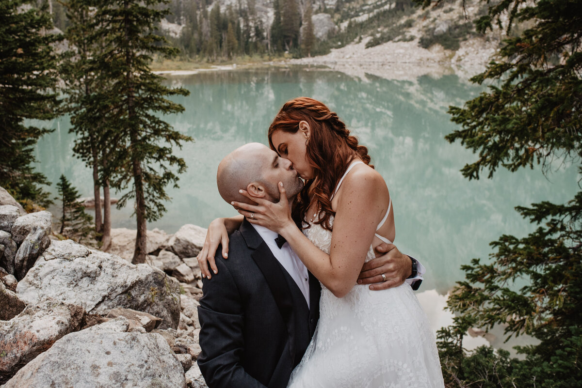 Jackson Hole Photographers capture bride and groom kissing during bridal portraits