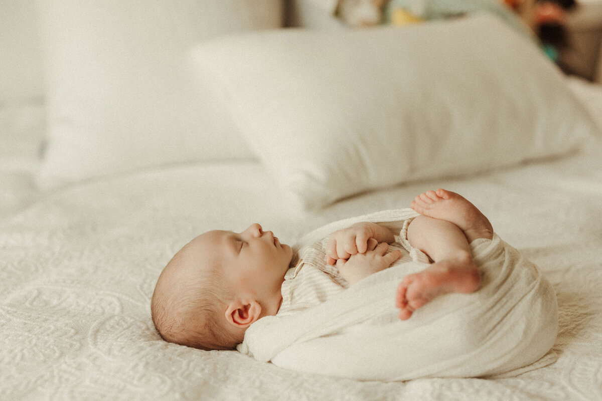 Parents holding newborn during Franklin Tennessee in-home newborn photography