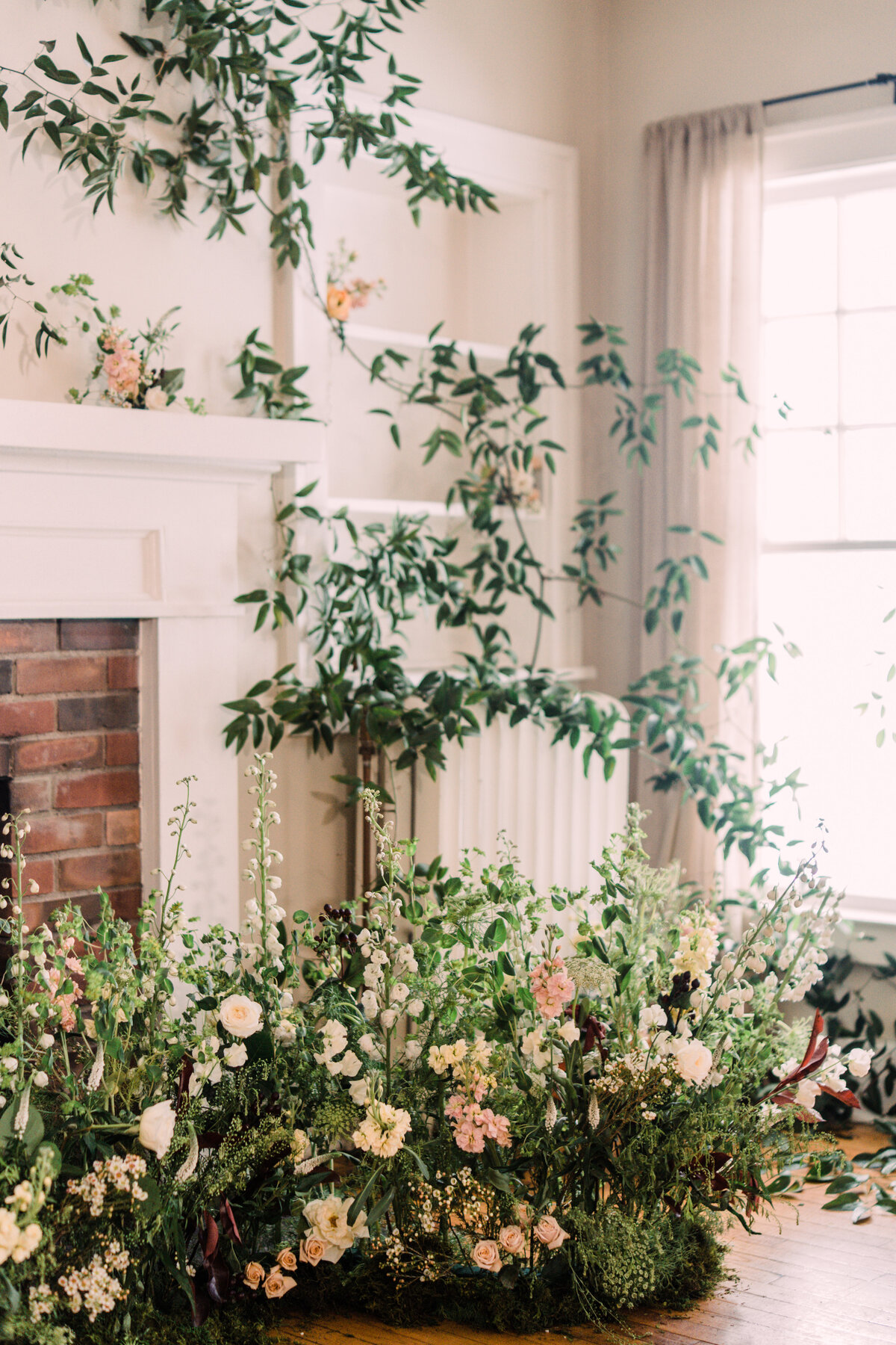 Dining room at Zingerman's Cornman Farms decorated with enchanted indoor garden wedding ceremony nest & vine-covered walls