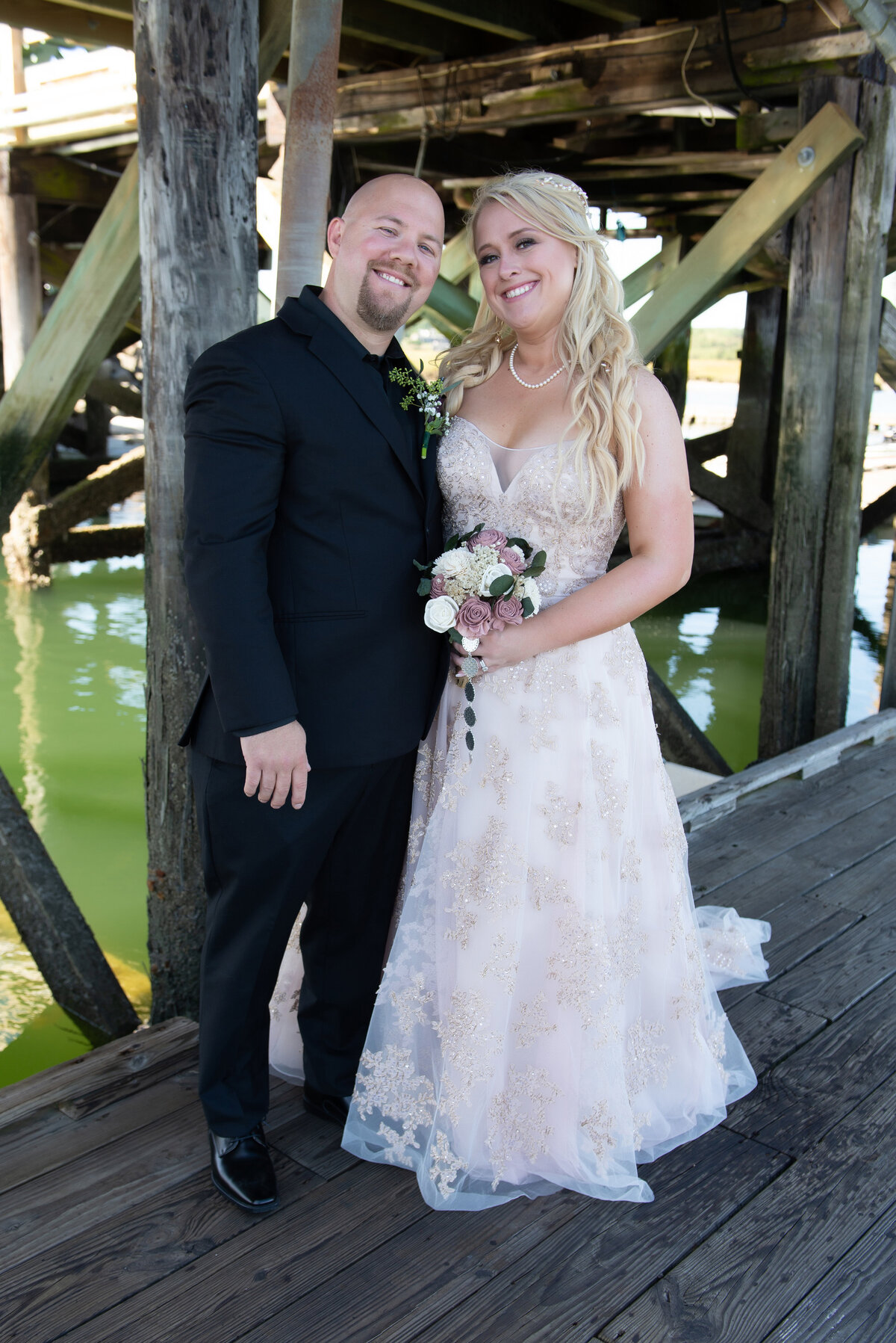 Bride and groom portrait on docks at Wells Harbor Maine