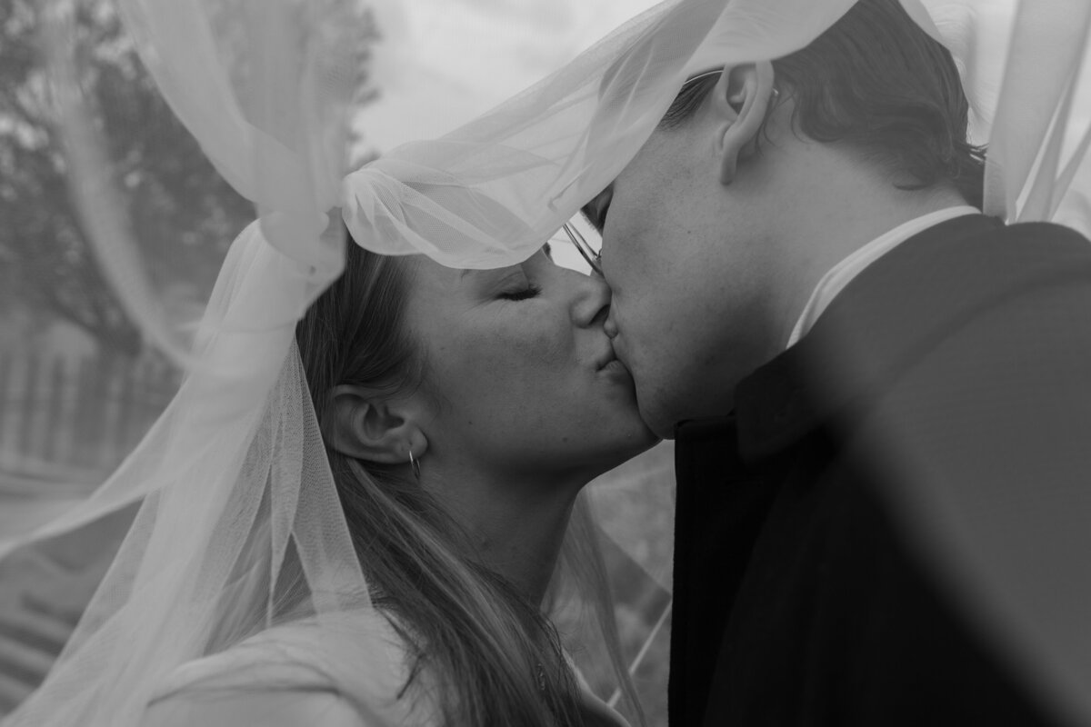 Intimate couple kiss during London elopement, documentary wedding photography by The Falkenburgs Studio