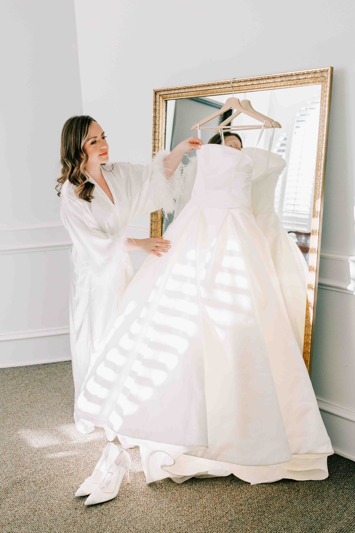 brides adores her gown on her wedding day