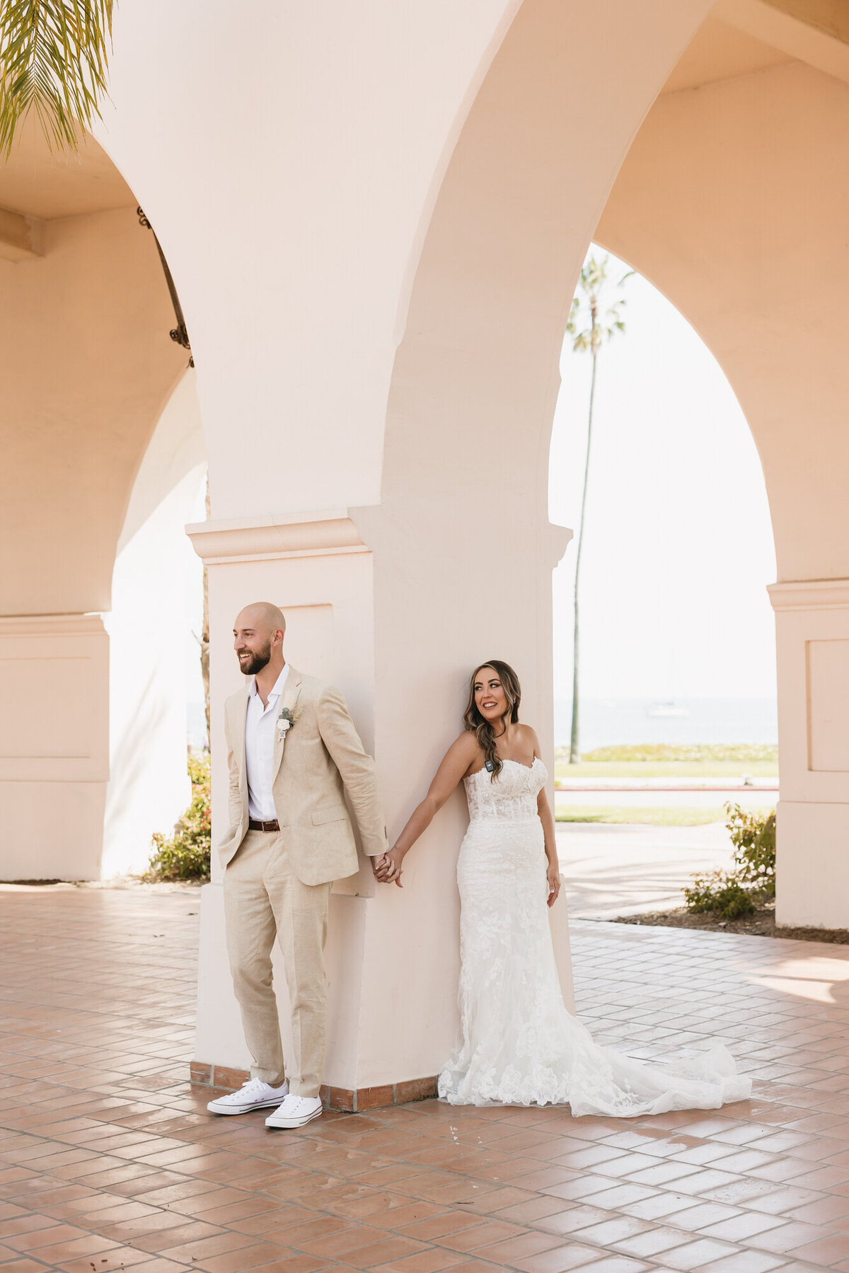 Couple holding hands during first touch at Hilton Beachfront Resort Santa Barbara