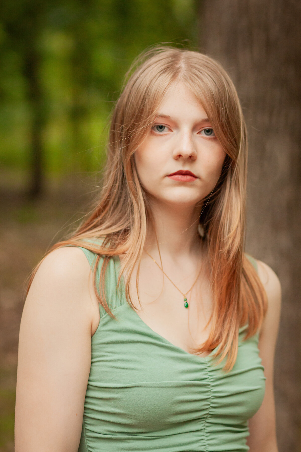 piercing eyes girl with green shirt serious look