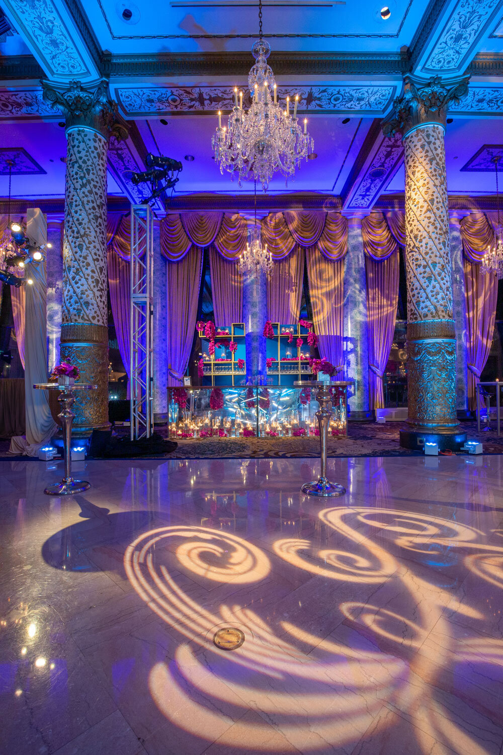 Event space with ornate pillars and dramatic lighting