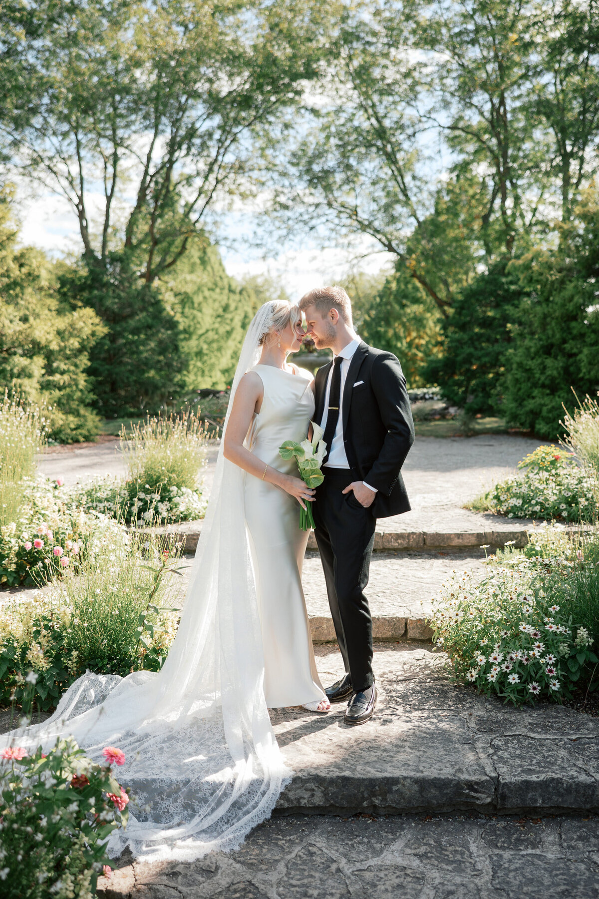 Couple shares intimate moment in Dayton garden venue, photographed by Philadelphia-based wedding photographer.