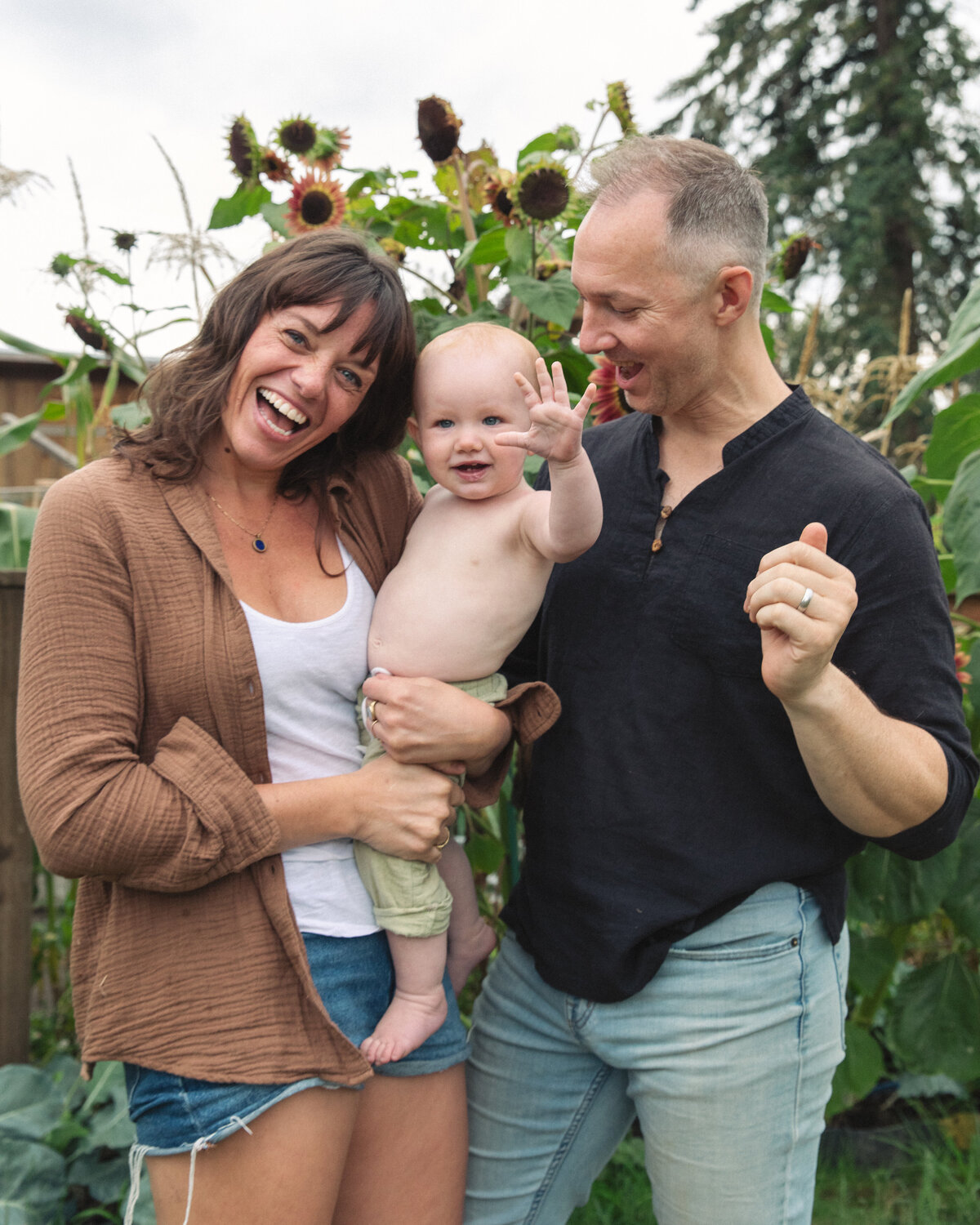 Parents holding their baby outdoors for family portraits. Beautiful and natural family photography in Portland and Nashville.