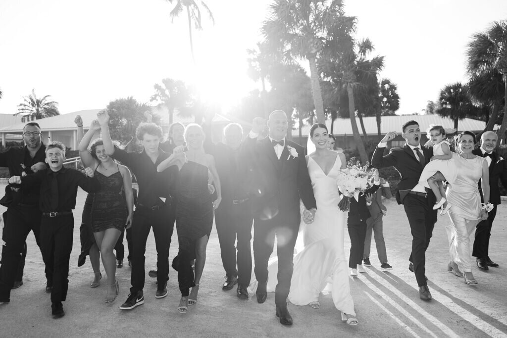 A heartwarming moment as the newlyweds are congratulated by loved ones after their oceanfront wedding ceremony. Captured by Florida Keys wedding photographer Claudia Amalia Photography.