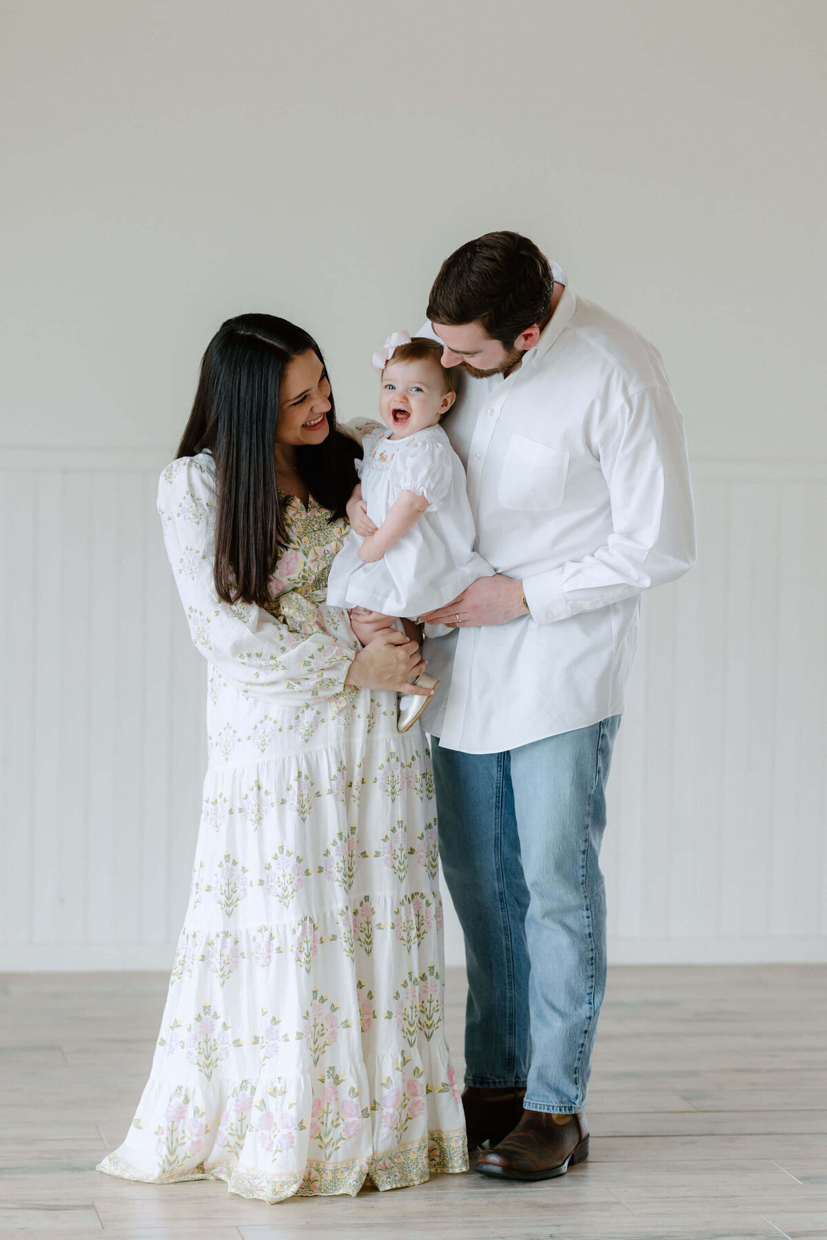 candid spring family picture of young family in neutral colors