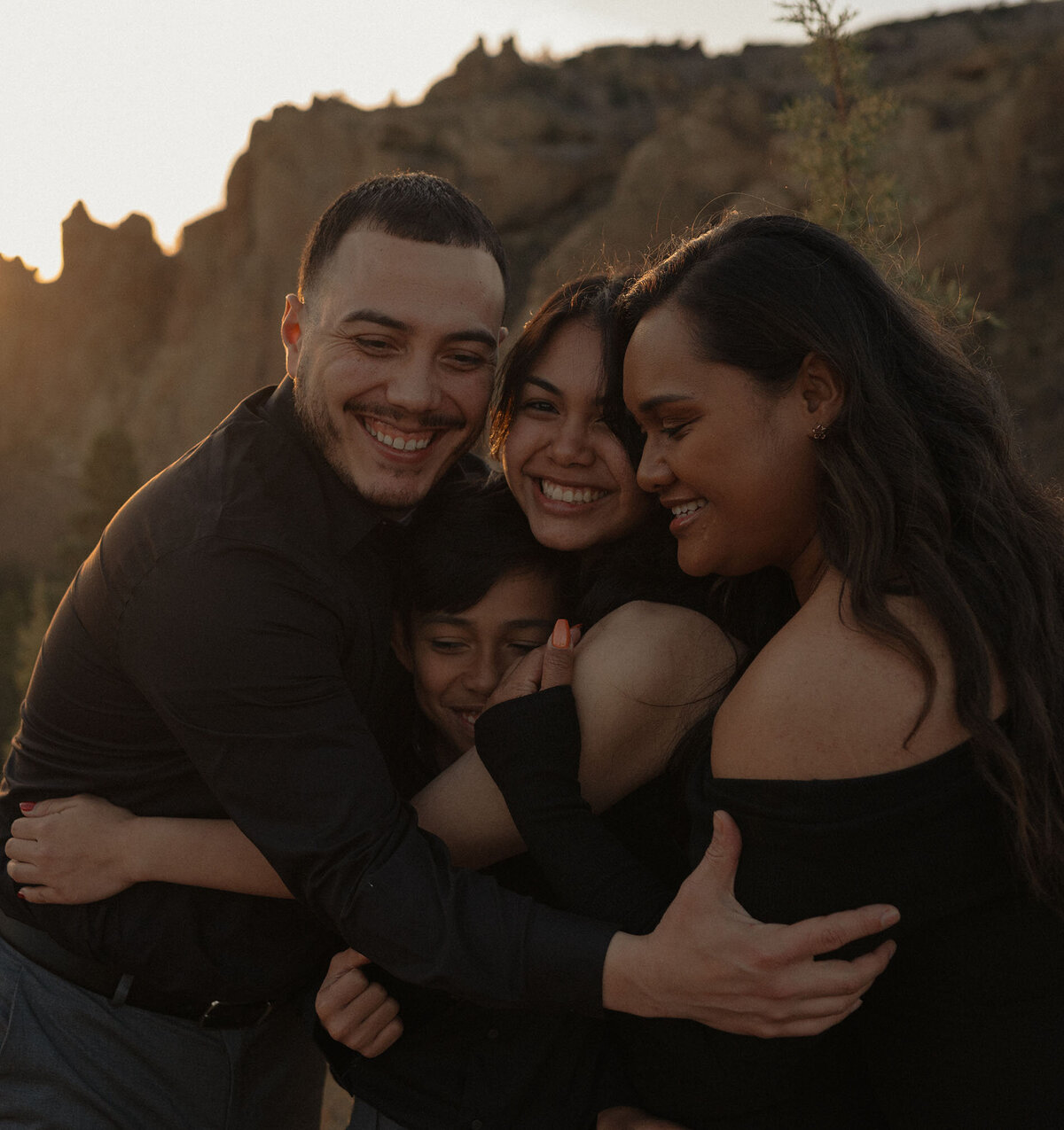 family of four having fun together, being playful and silly outdoors in Bend, Oregon