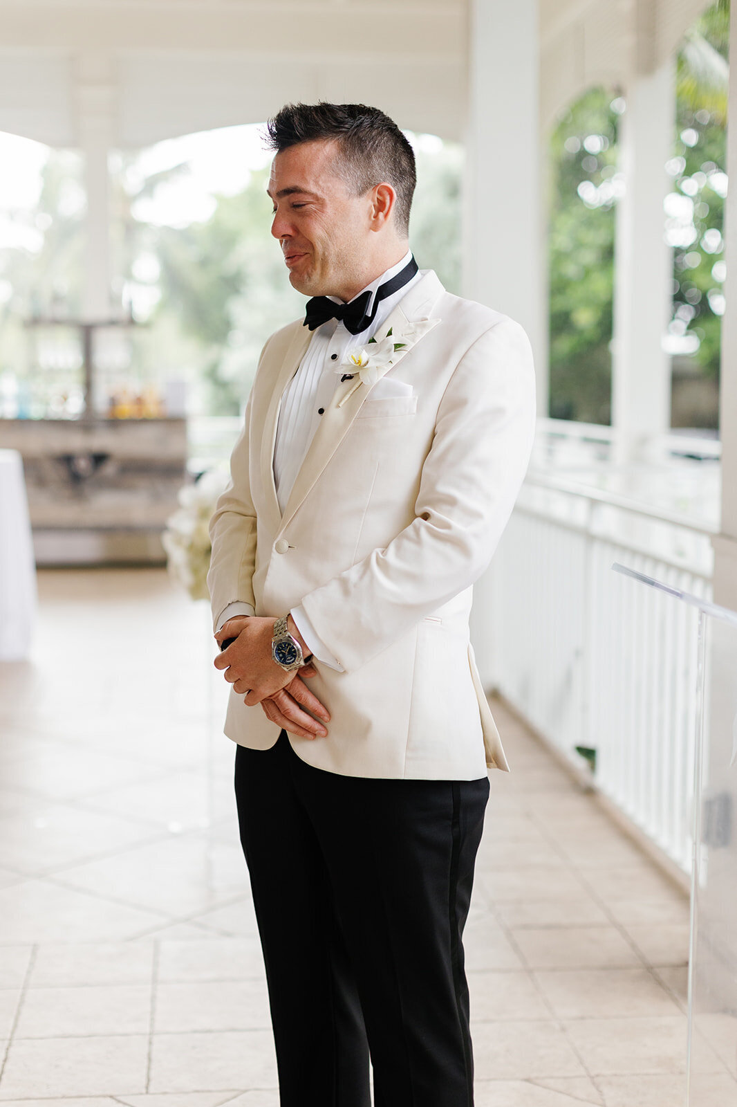 The groom waiting in anticipation at the ceremony venue during an intimate wedding at Ocean Reef in Key Largo, captured by Claudia Amalia Photography.