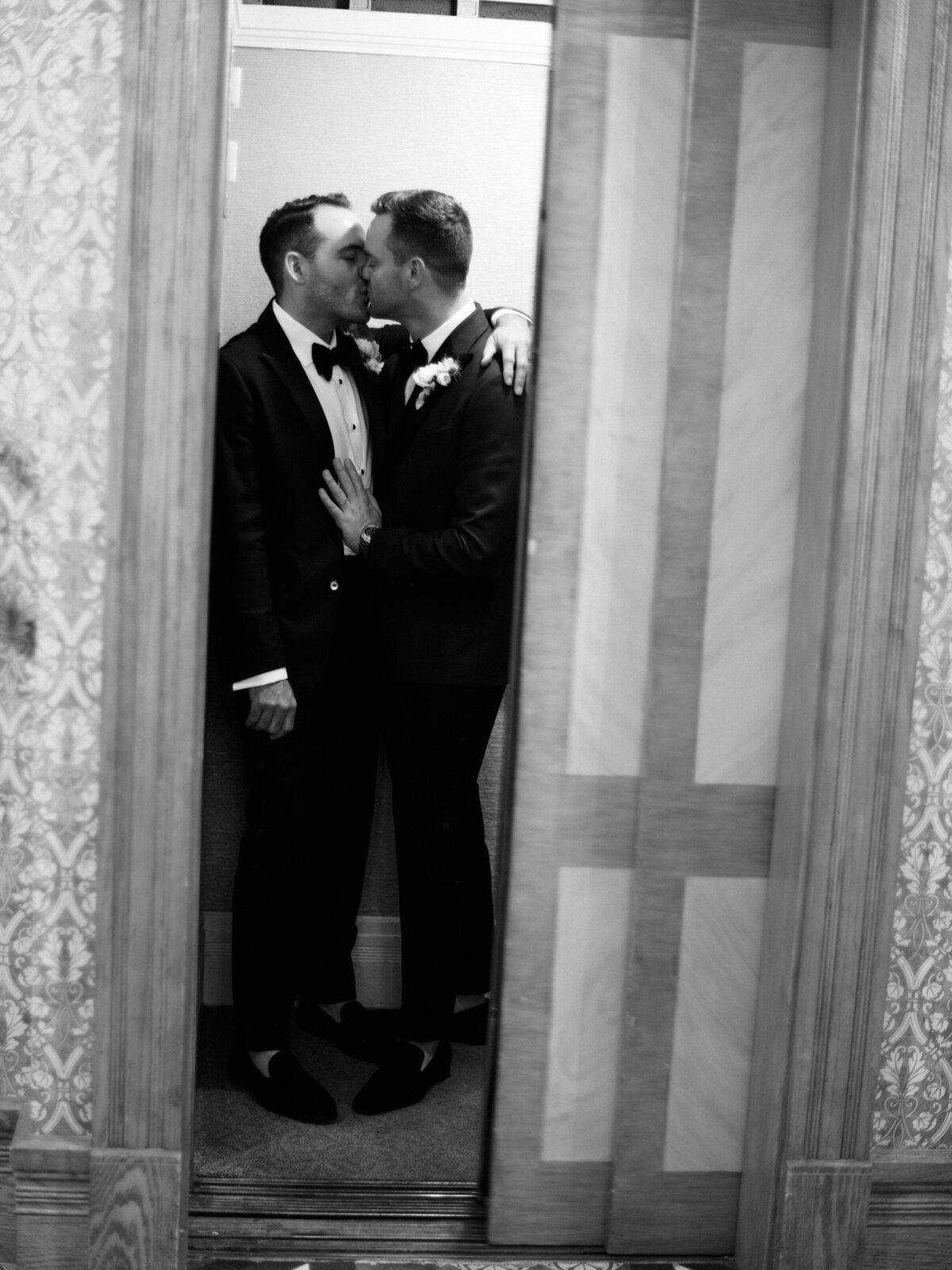 A romantic kiss shared by a couple in a quaint elevator setting, symbolizing love confined in a lovely moment, filled with emotion and intimacy, perfect for wedding memories.