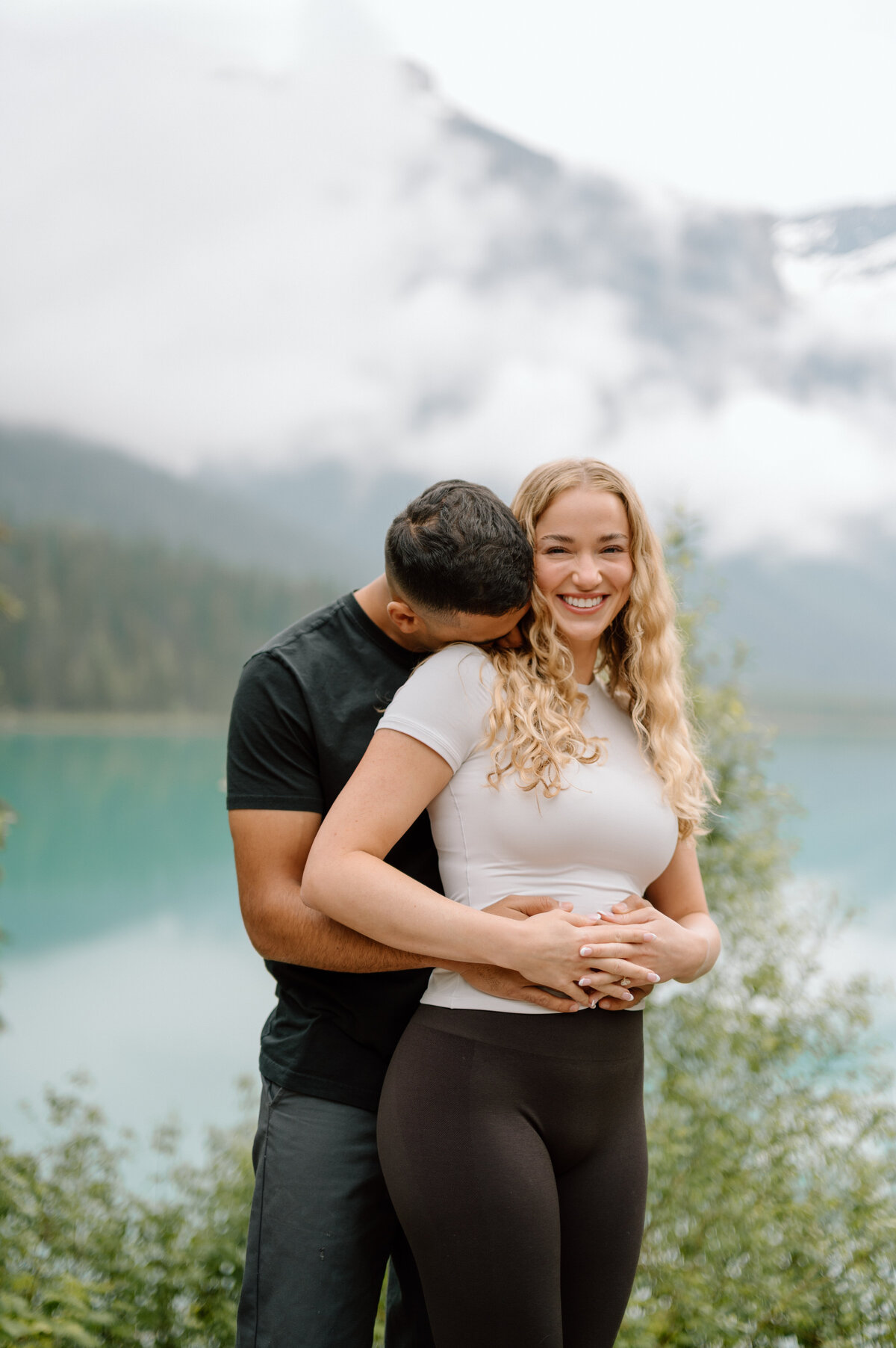 man hugging girlfriend with immense happiness after proposal.