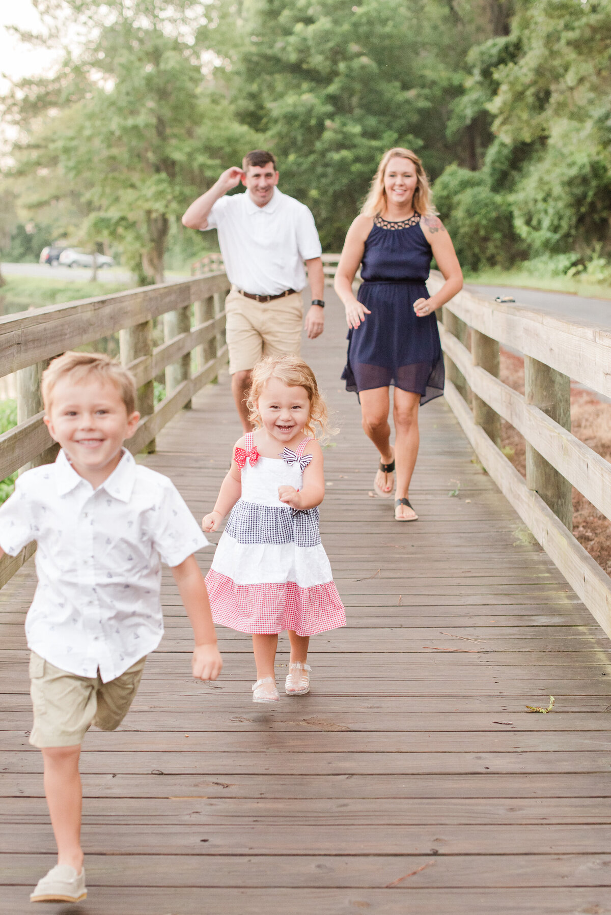 family of 4 running on the bridge