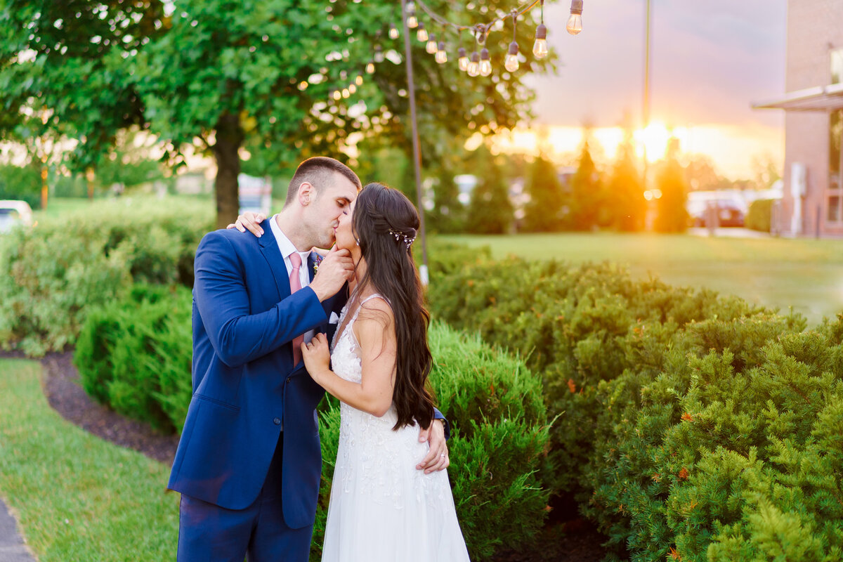Bride and groom kiss at sunset at their wedding at the Renaissance Hotel in Westerville, Ohio.