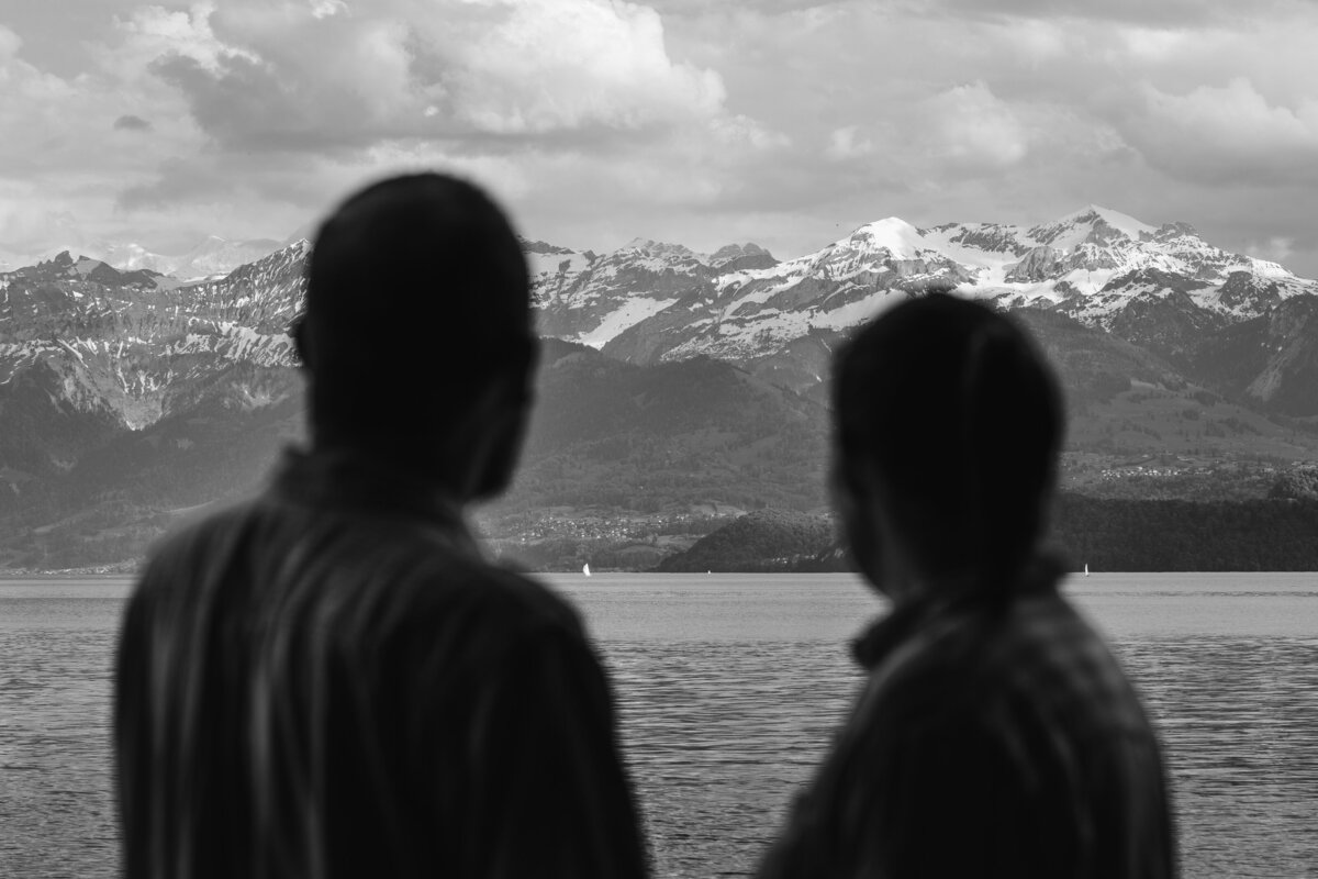 A couple looking out over a mountain lake