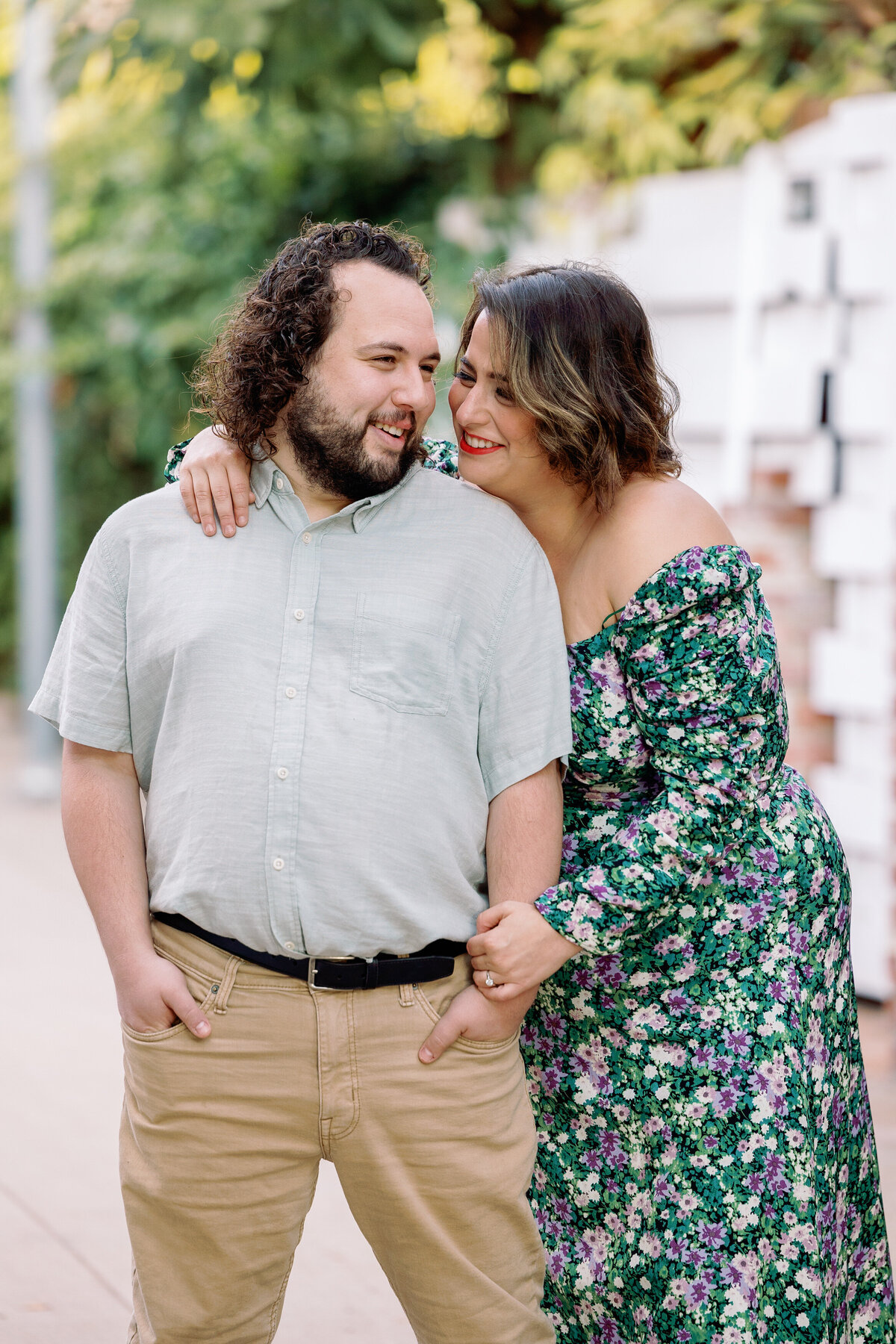 A couple with their arms around each other smiling