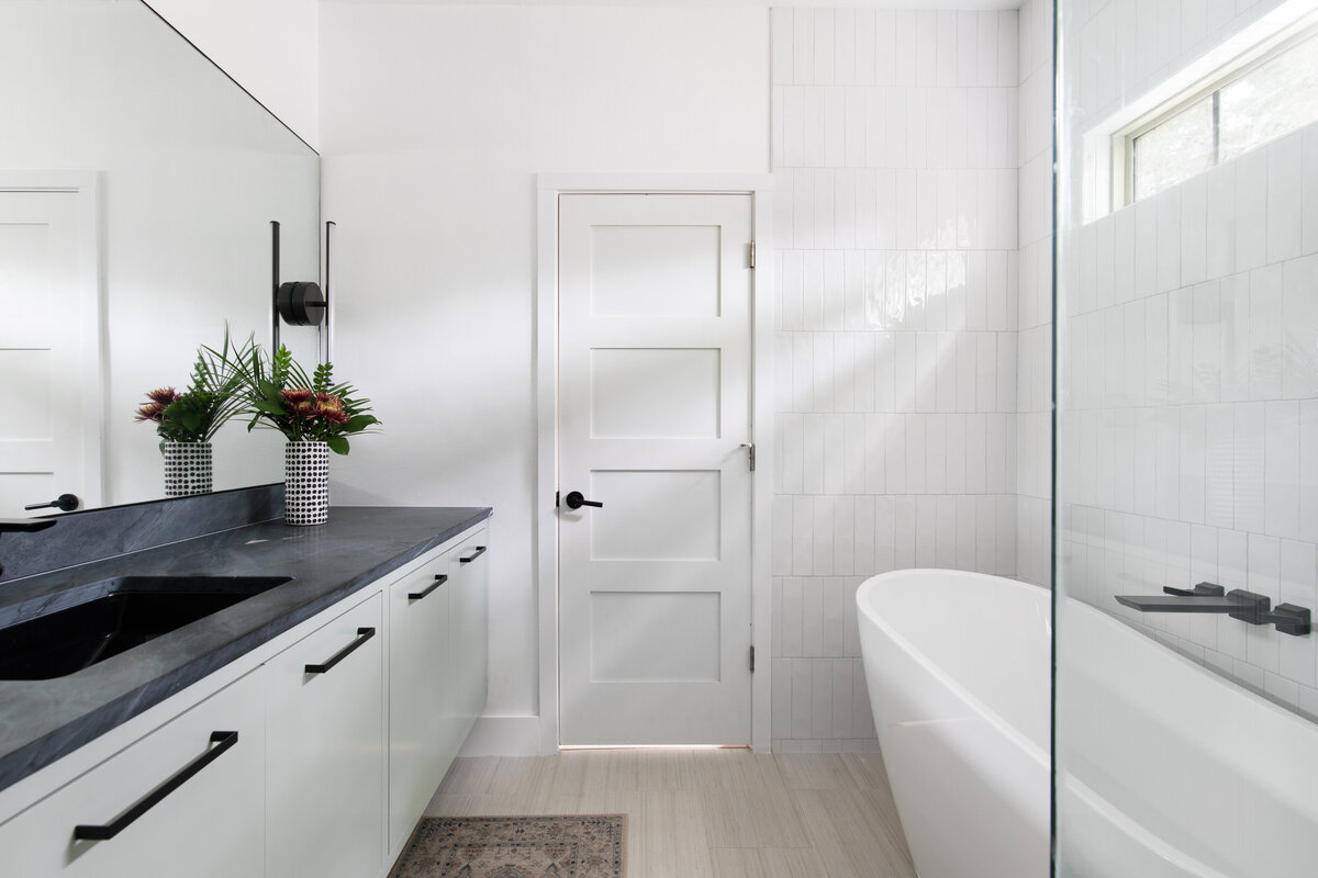 hello-home-sleek-modern-bathroom-design-black-countertops-glass-shower-freestanding-tub-austin-5