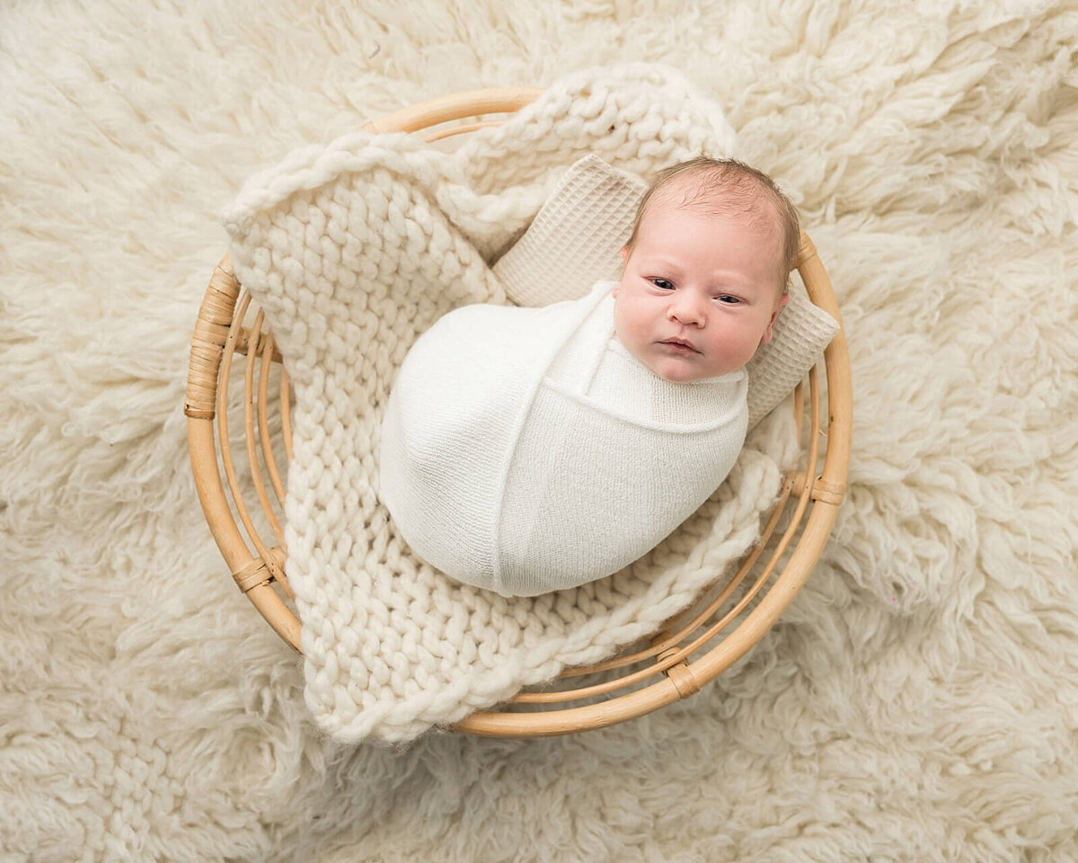 baby boy looking at camera in sherwood newborn photography