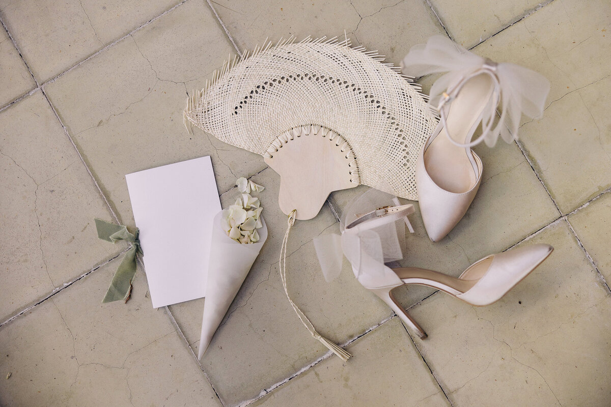 Flat lay of rustic Tuscany wedding stationery in ivory and sage tones