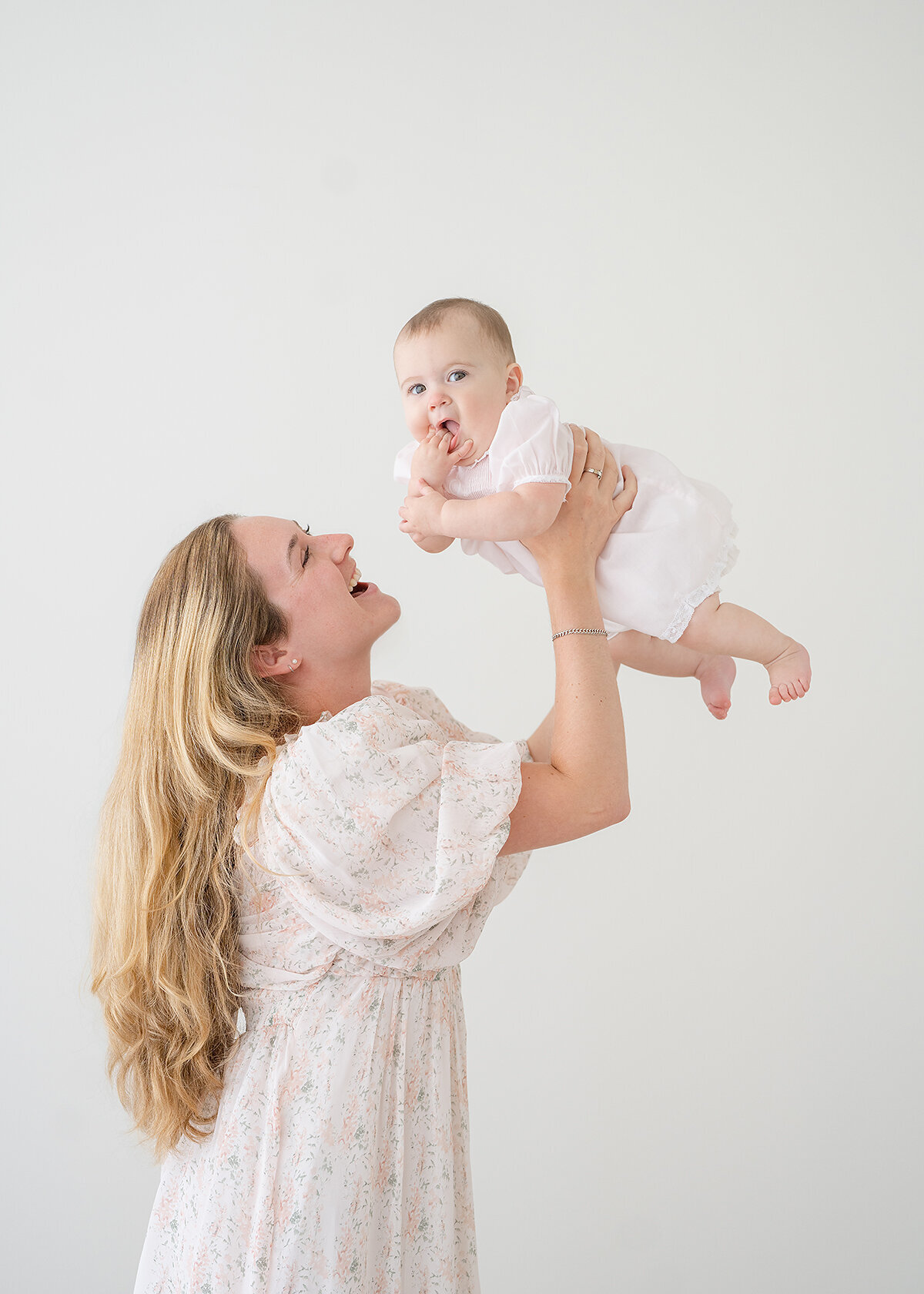 baby girl and her mother photographed in a studio in brunswick ga for her sitting milestone
