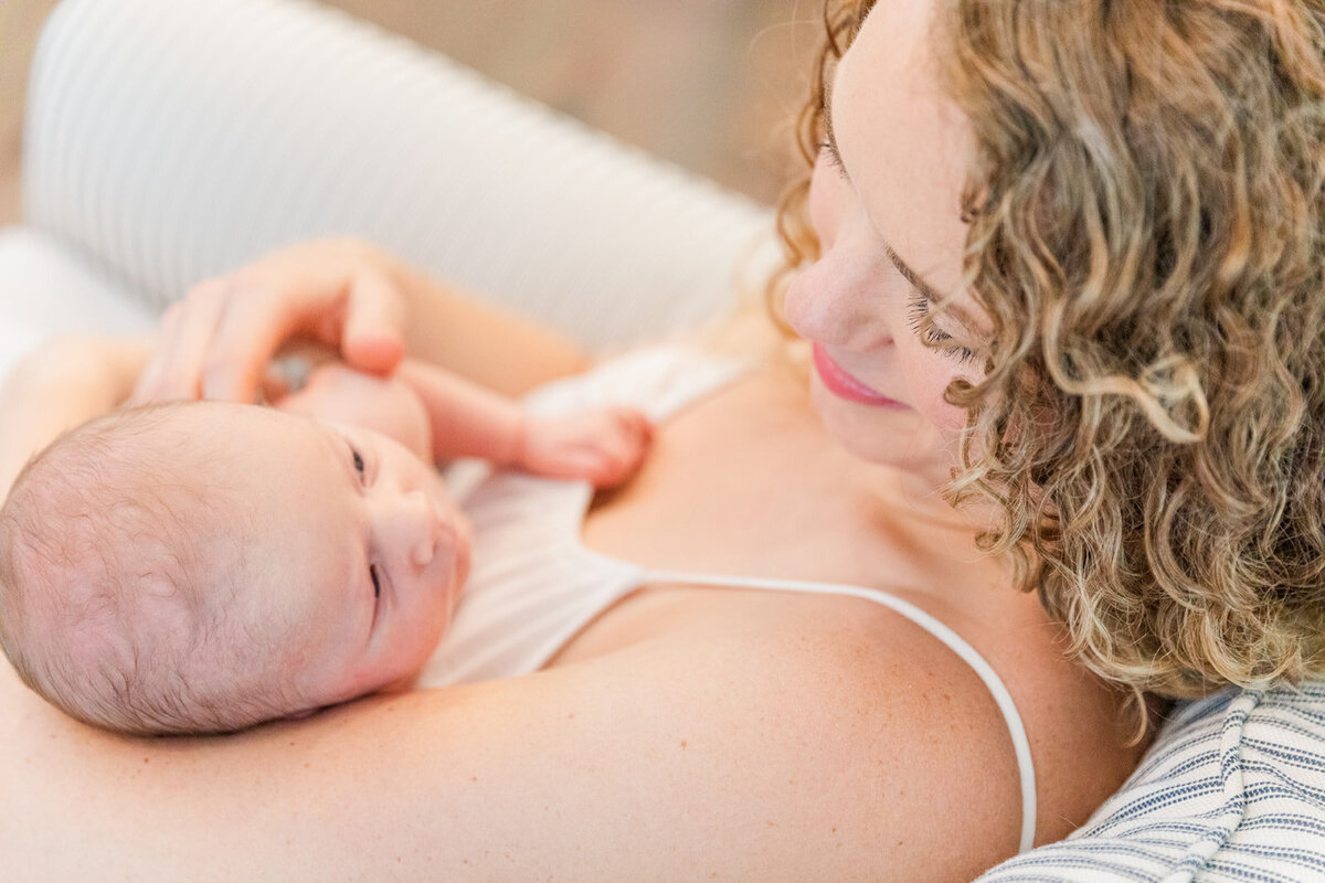 mum looking and smiling at newborn baby