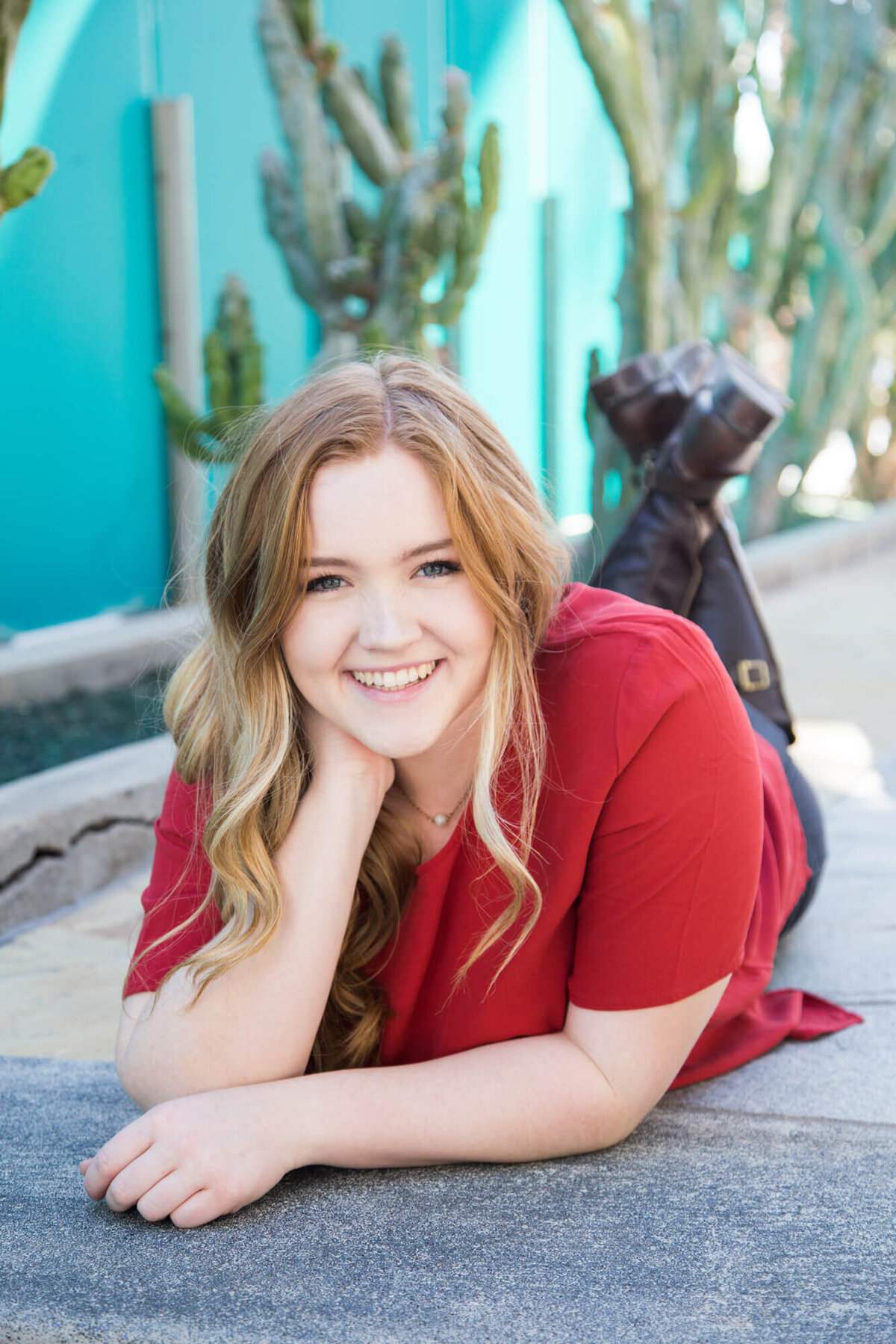 senior girl smiling on the ground