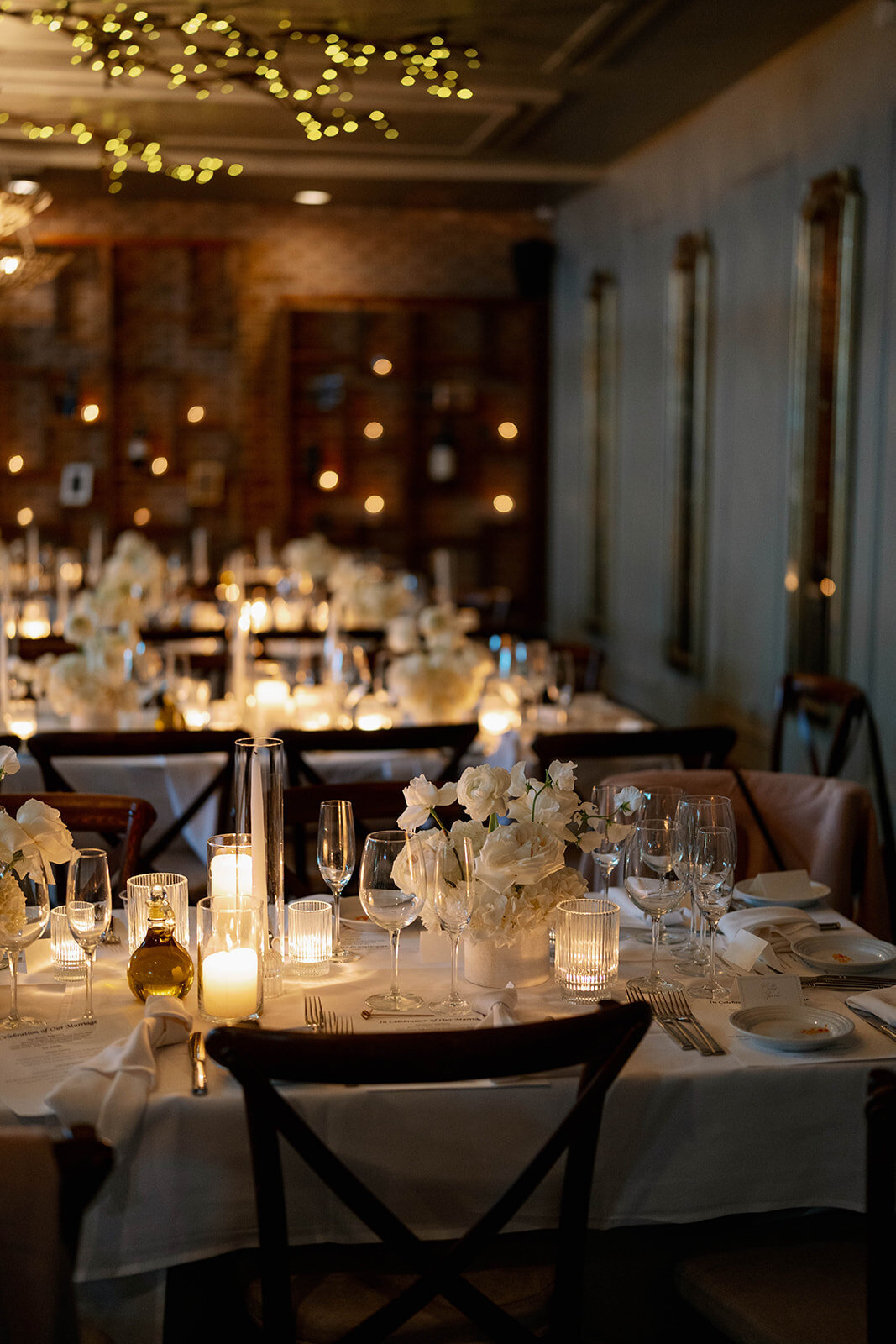 Warm candlelit indoor reception setup at Café Cortina, Michigan wedding décor photography.
