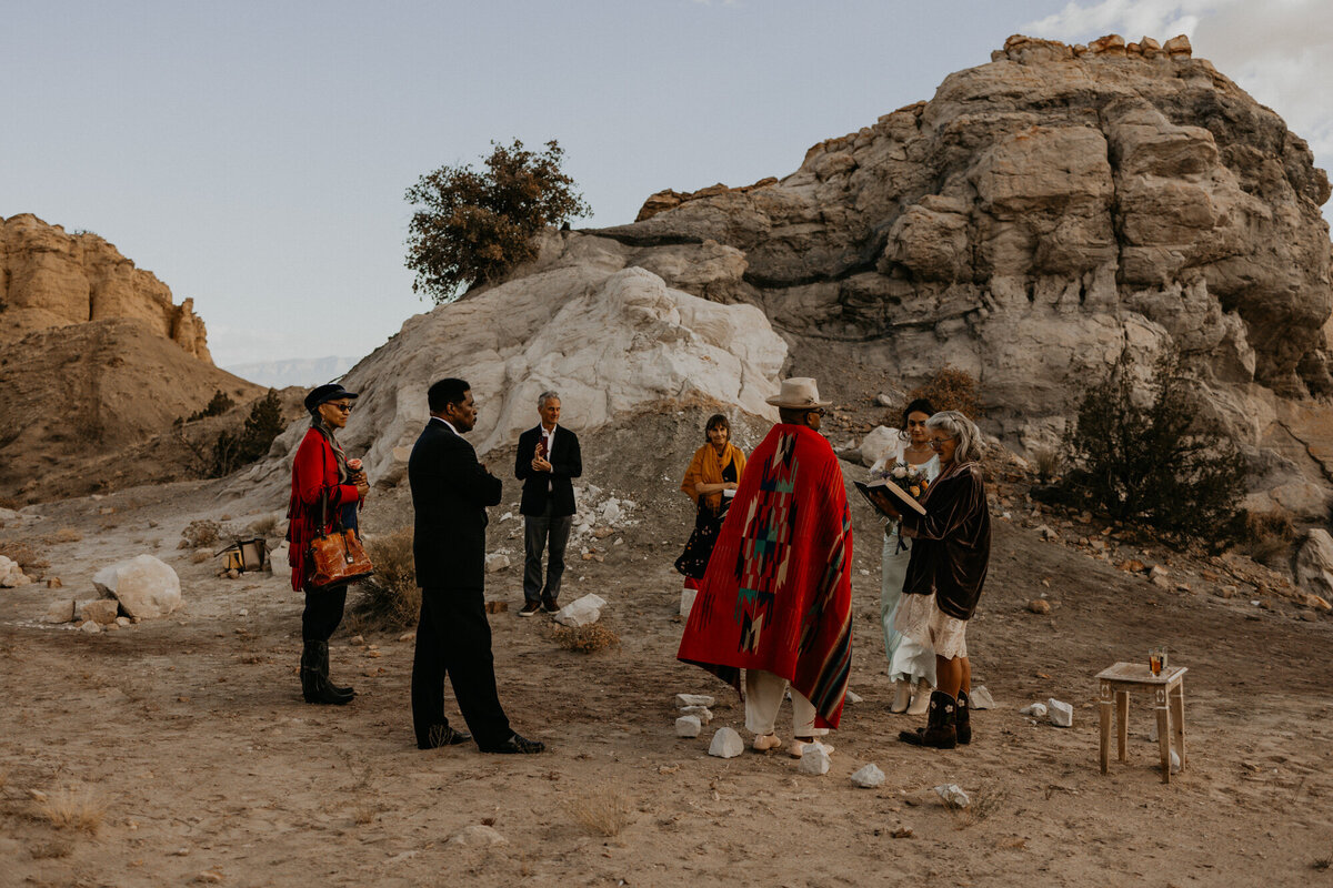 elopement ceremony with just the couple and their parents among beautiful rock formations in New Mexico