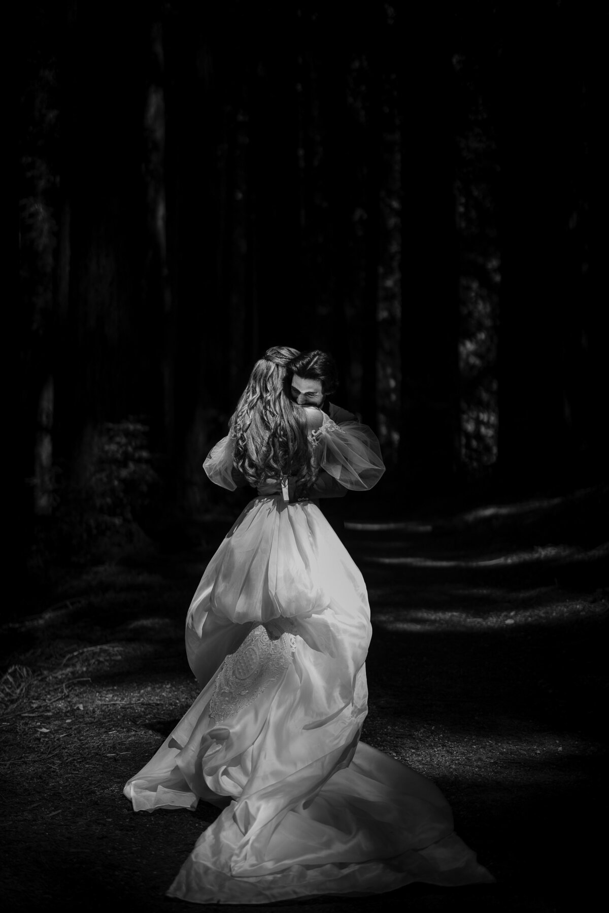 A couple embraces in the woods at a destination wedding at Nestldown in Los Gatos, California