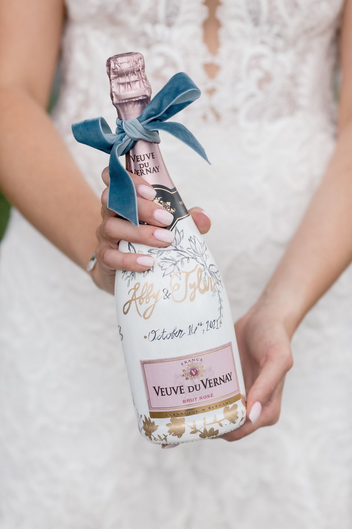 bride-holds-painted-wedding-champagne-bottle