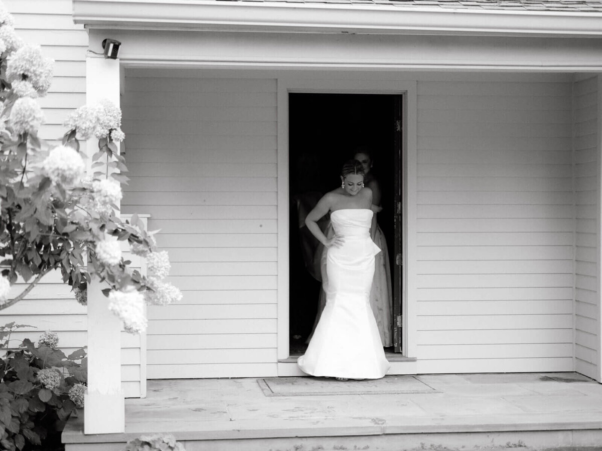 The gorgeous bride is coming out of the guest house at Lion Rock Farm, CT.  Image by Jenny Fu Studio