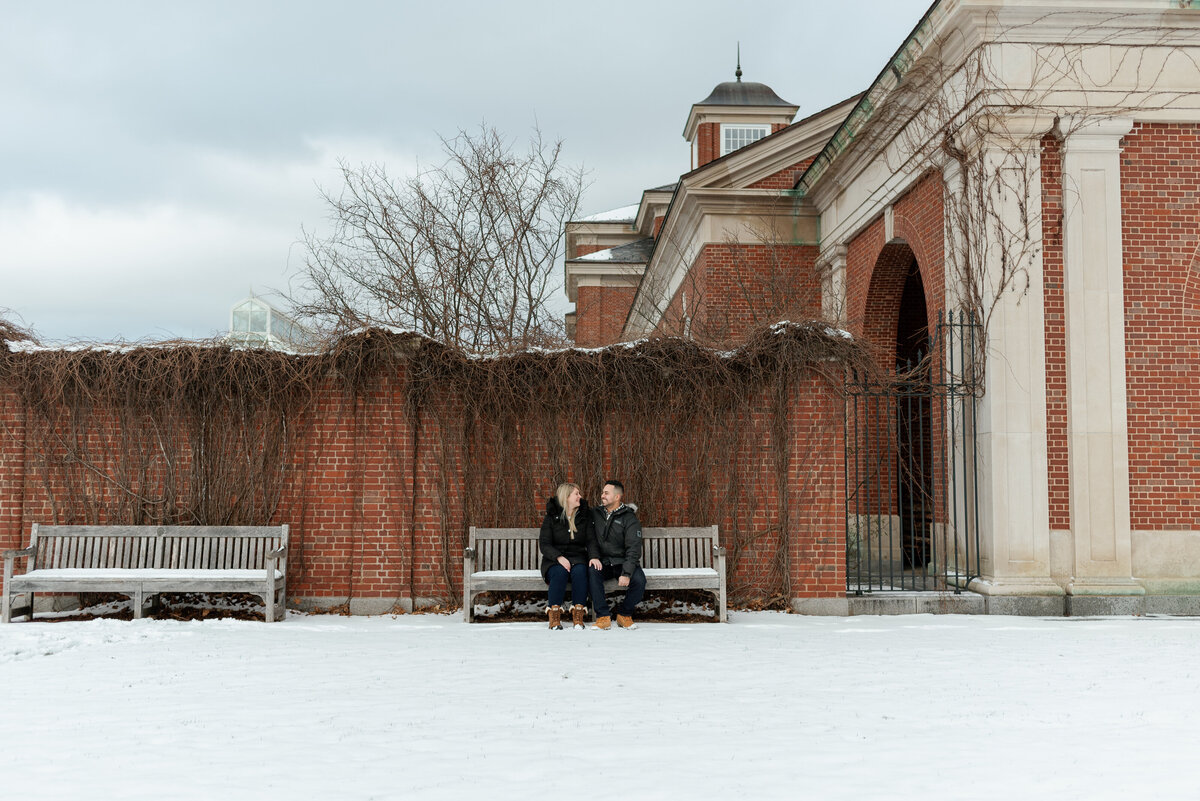 Couple sitting on the bench in the winter in Halifax.