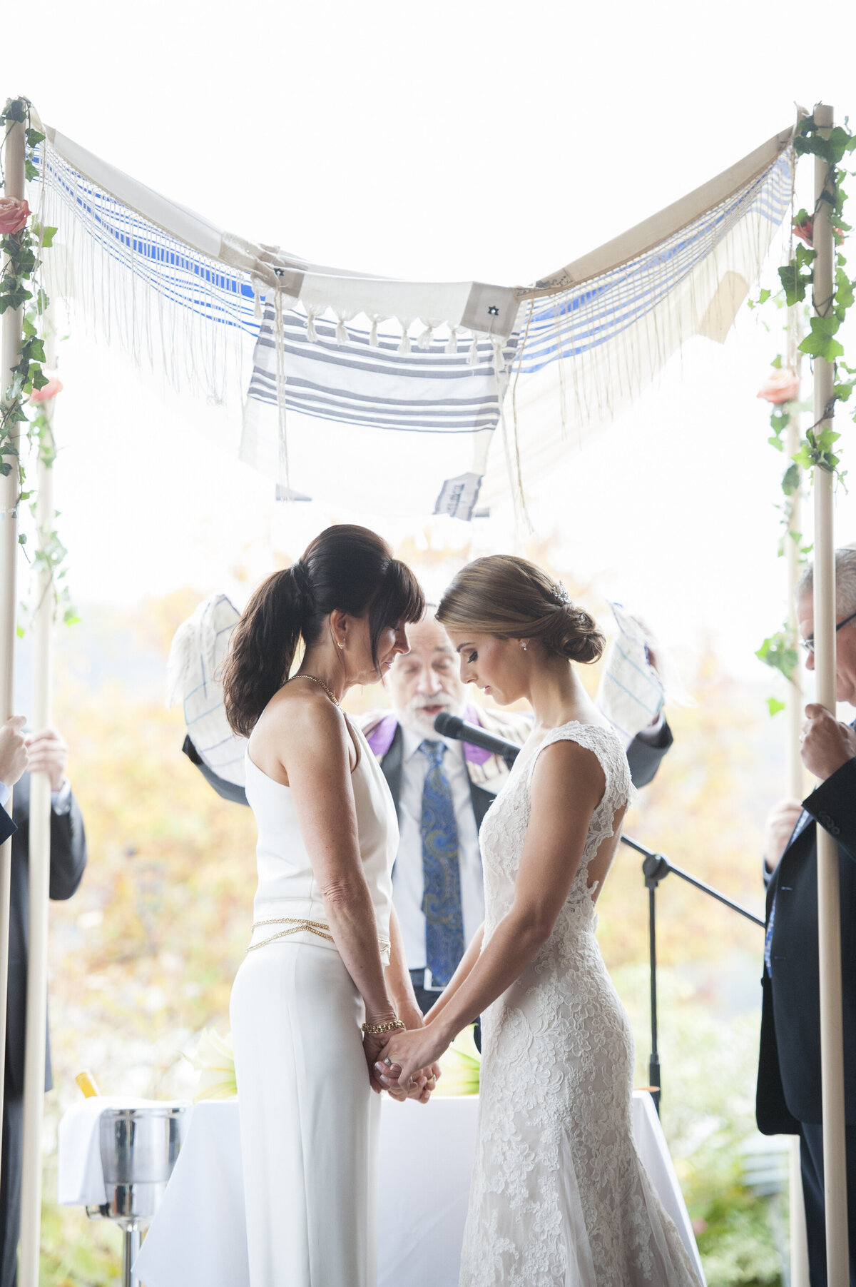Newlyweds holding hands during their wedding ceremony 