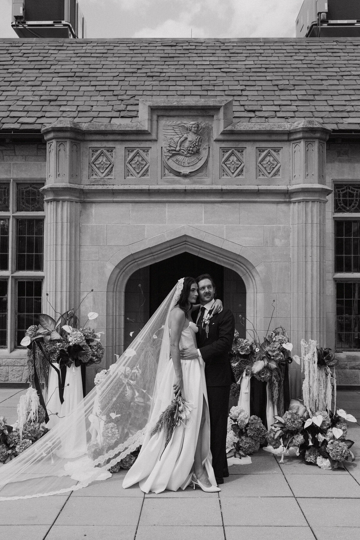Couple surrounded by lush flowers basque waist dress