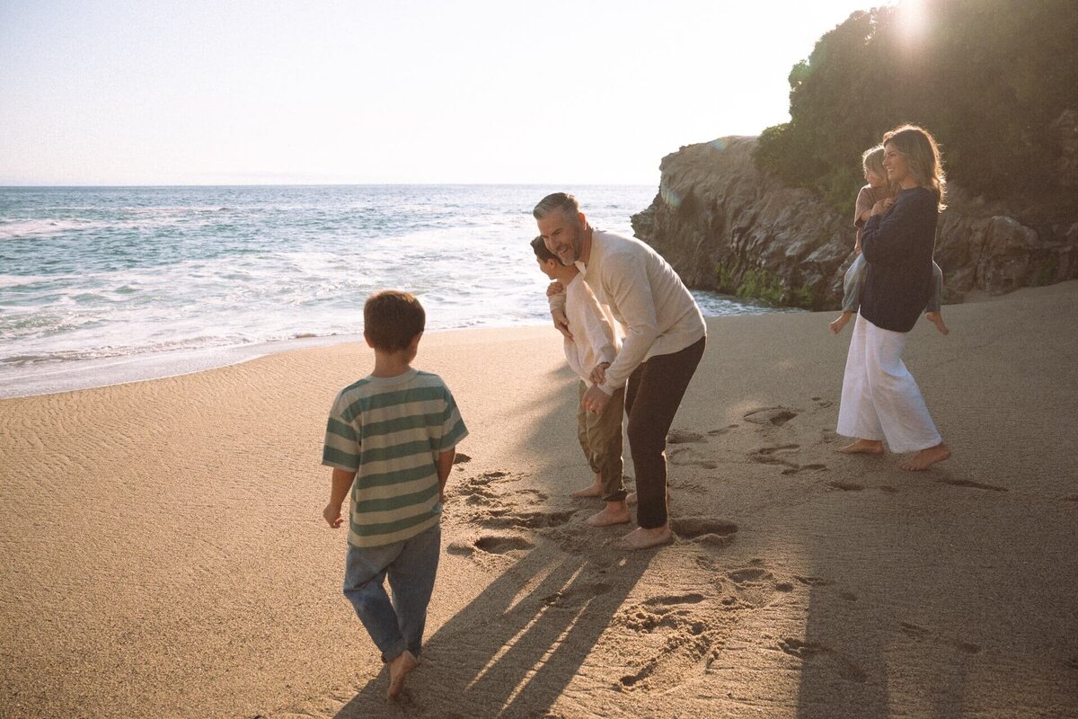 family of five photos at tablerock beach in laguna