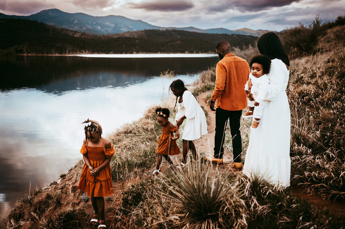 Family walking alongside a lake