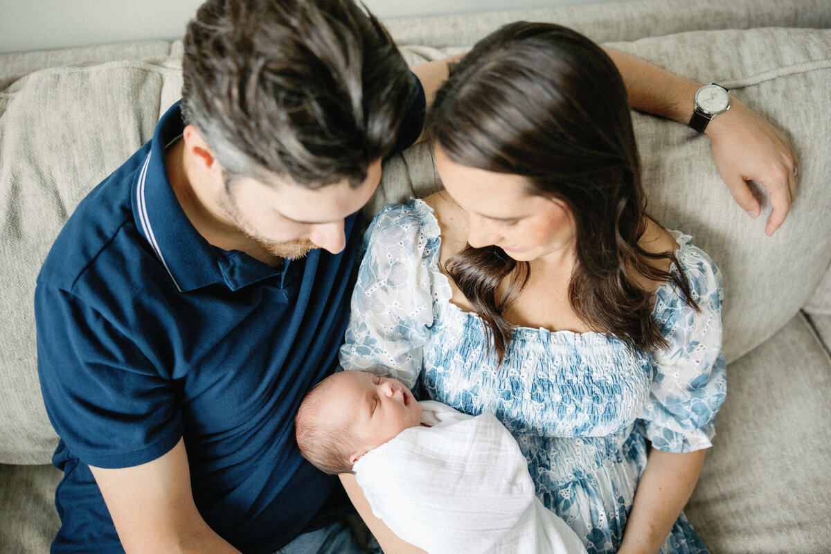 photo looking down on mom and dad admiring baby boy