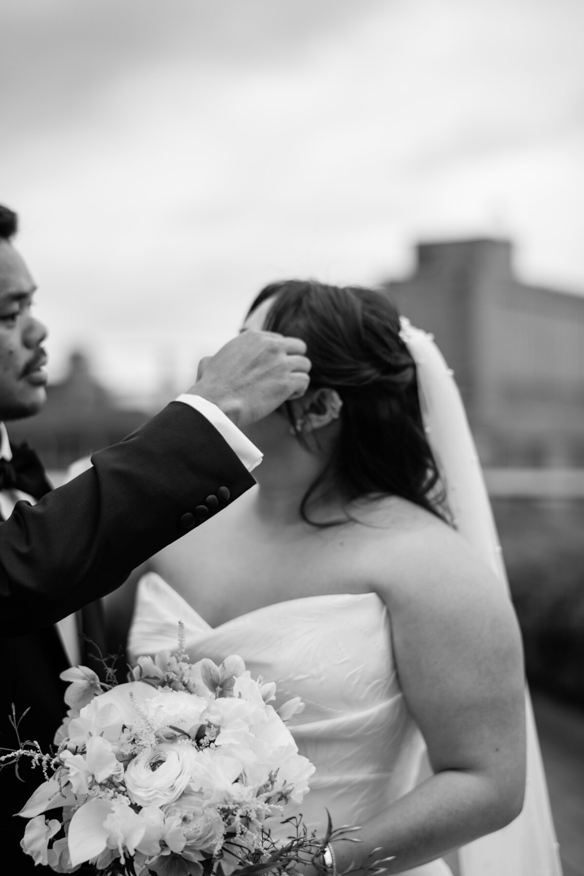 Groom moves brides hair to the side of her face